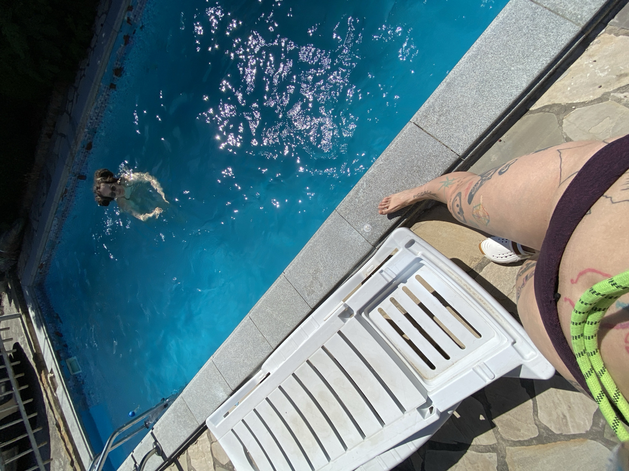 Poolside summer day in Mtskheta, tattoos, loquats, and a sleepy dog