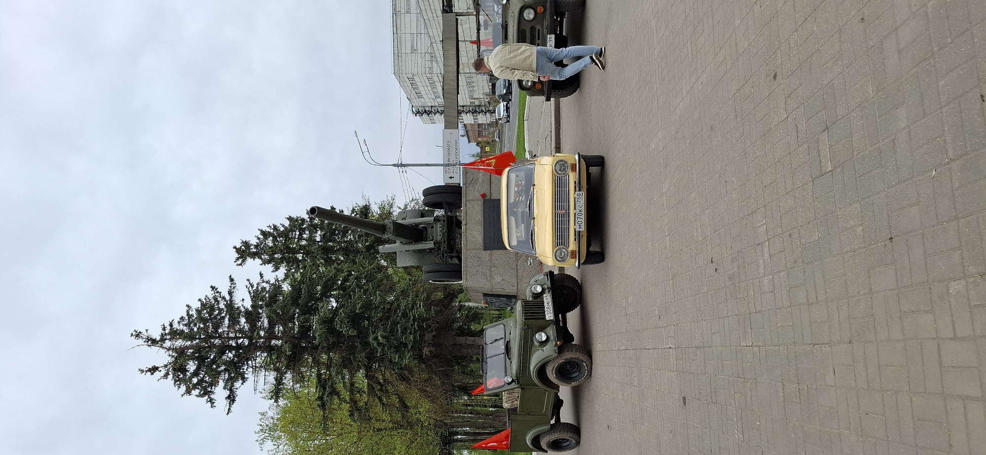 Family poses at military monument display in Klin, Russia