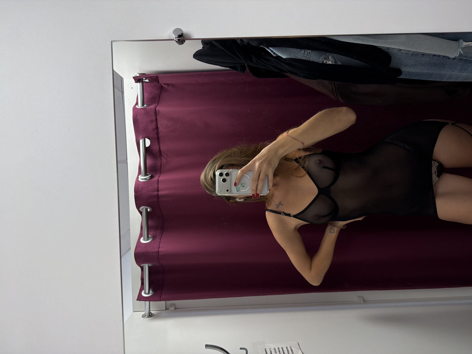 Woman tries on clothing in Nakhodka dressing room