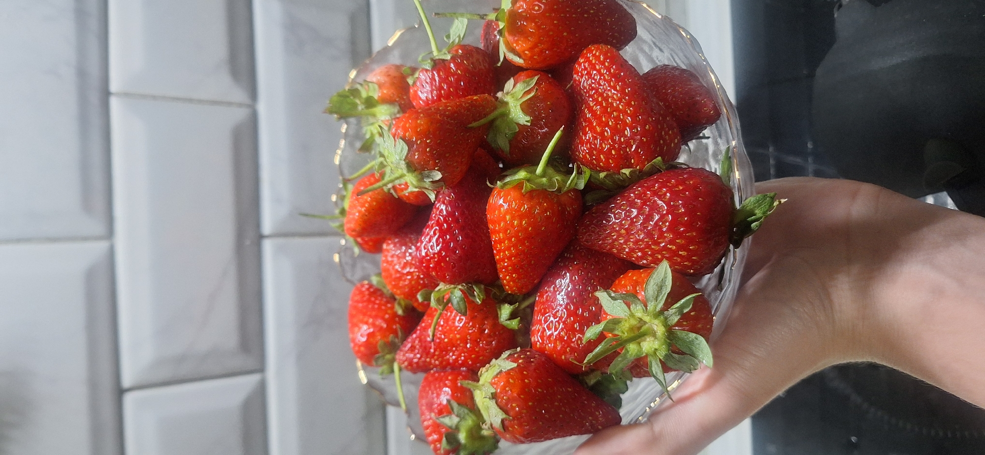 Fresh strawberries displayed in clear container in Moscow