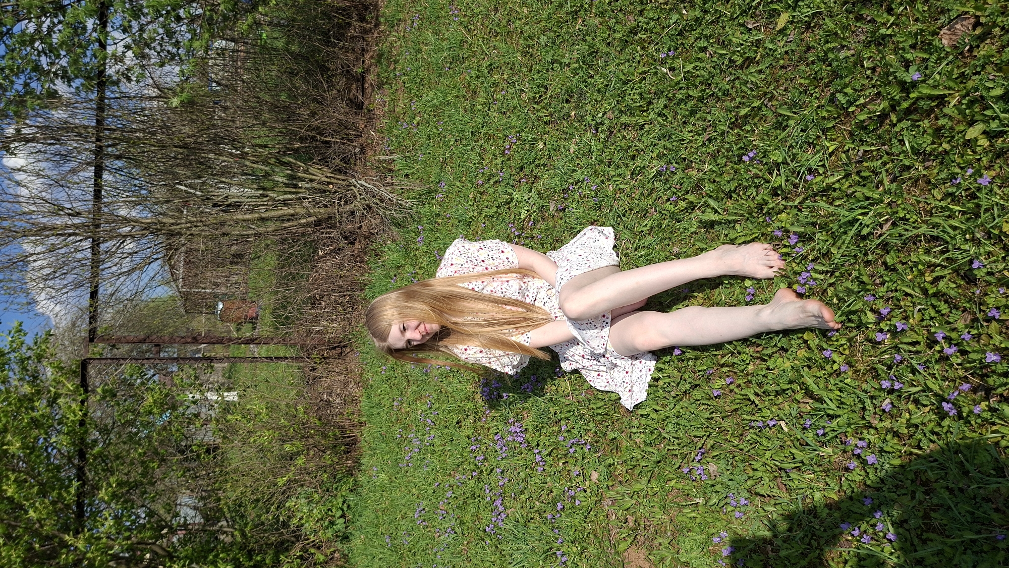 Woman relaxes in flower field in rural Russia