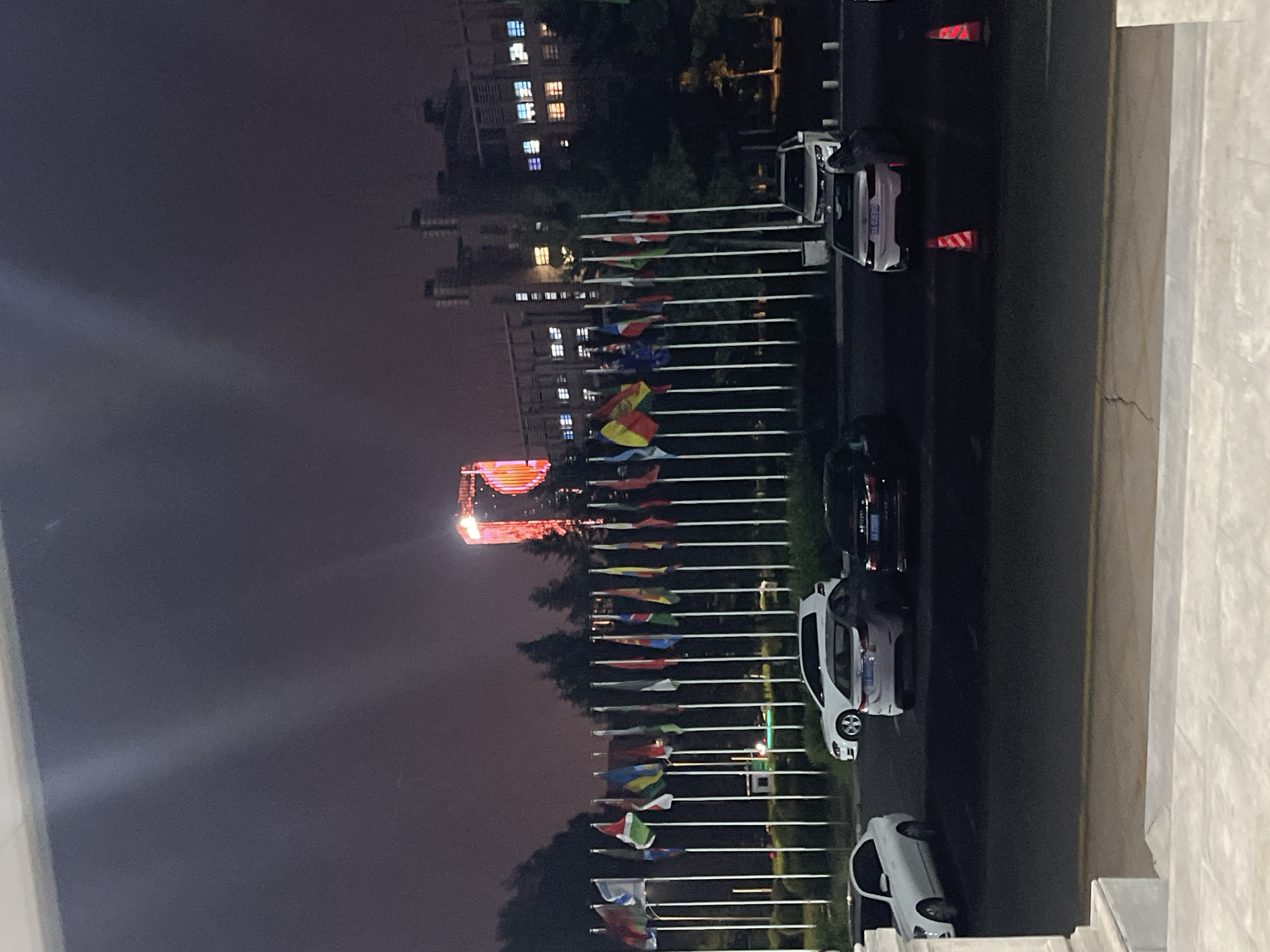 Evening pedestrian activity documented near international flag display in Changchun