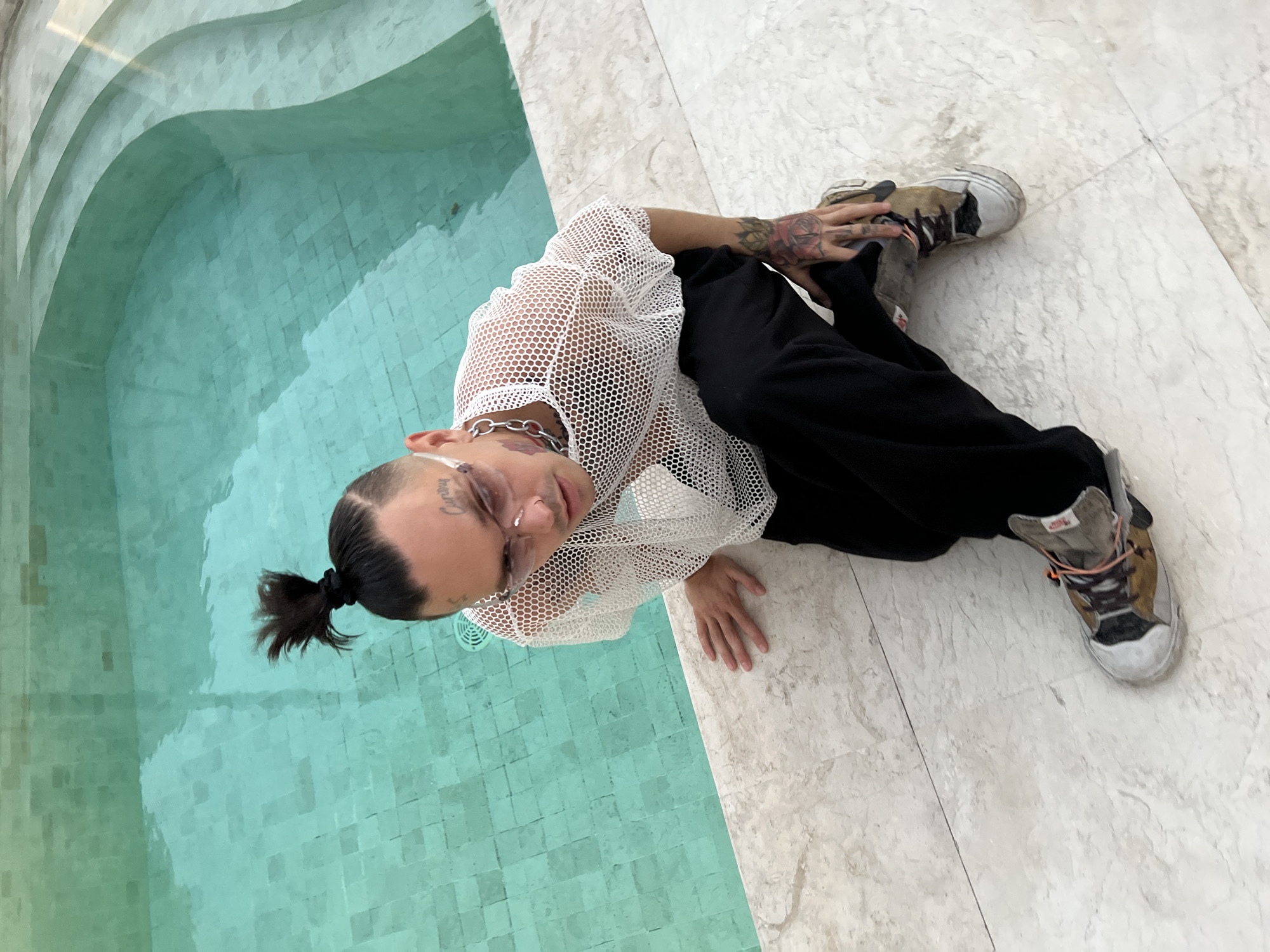 Poolside hang at a white villa with a black dog
