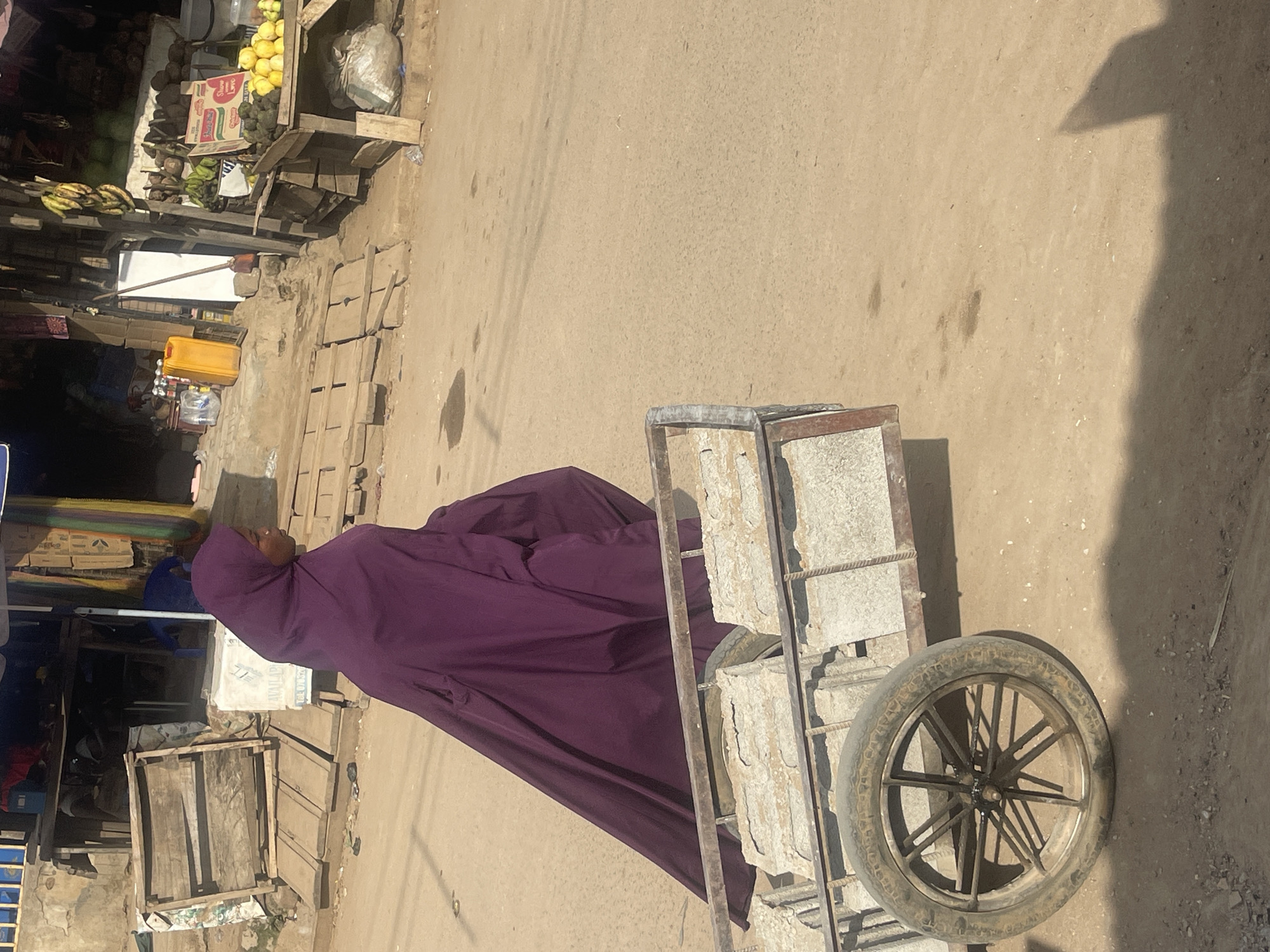 Everyday street and market life across Abuja's dusty midday roads