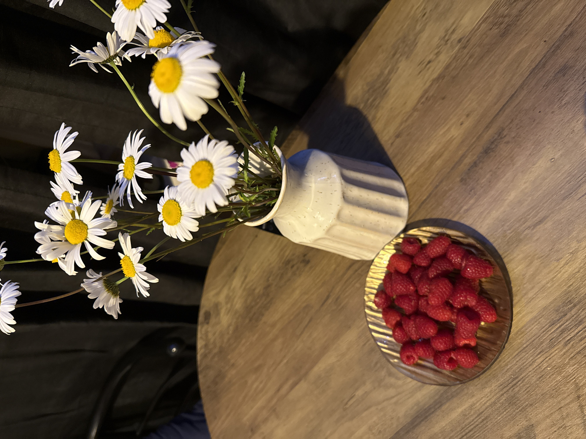Still-life scene with daisies and raspberries photographed in Great Yarmouth