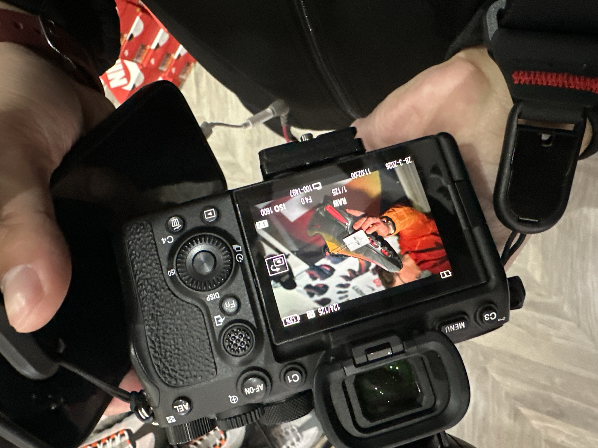 Person holds Sony camera with active LCD screen in Liverpool