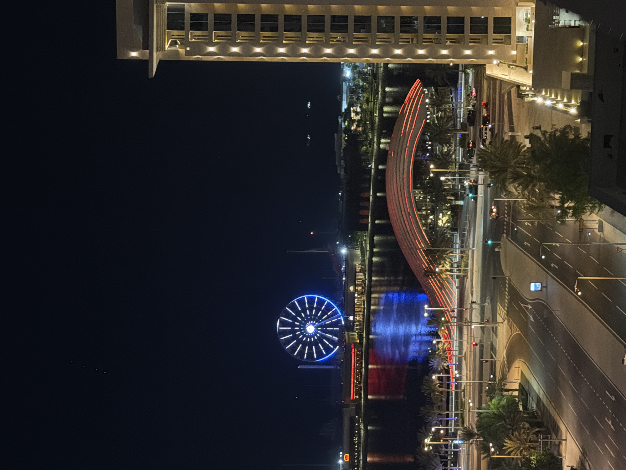 Lusail waterfront at night, Ferris wheel glowing over the bay