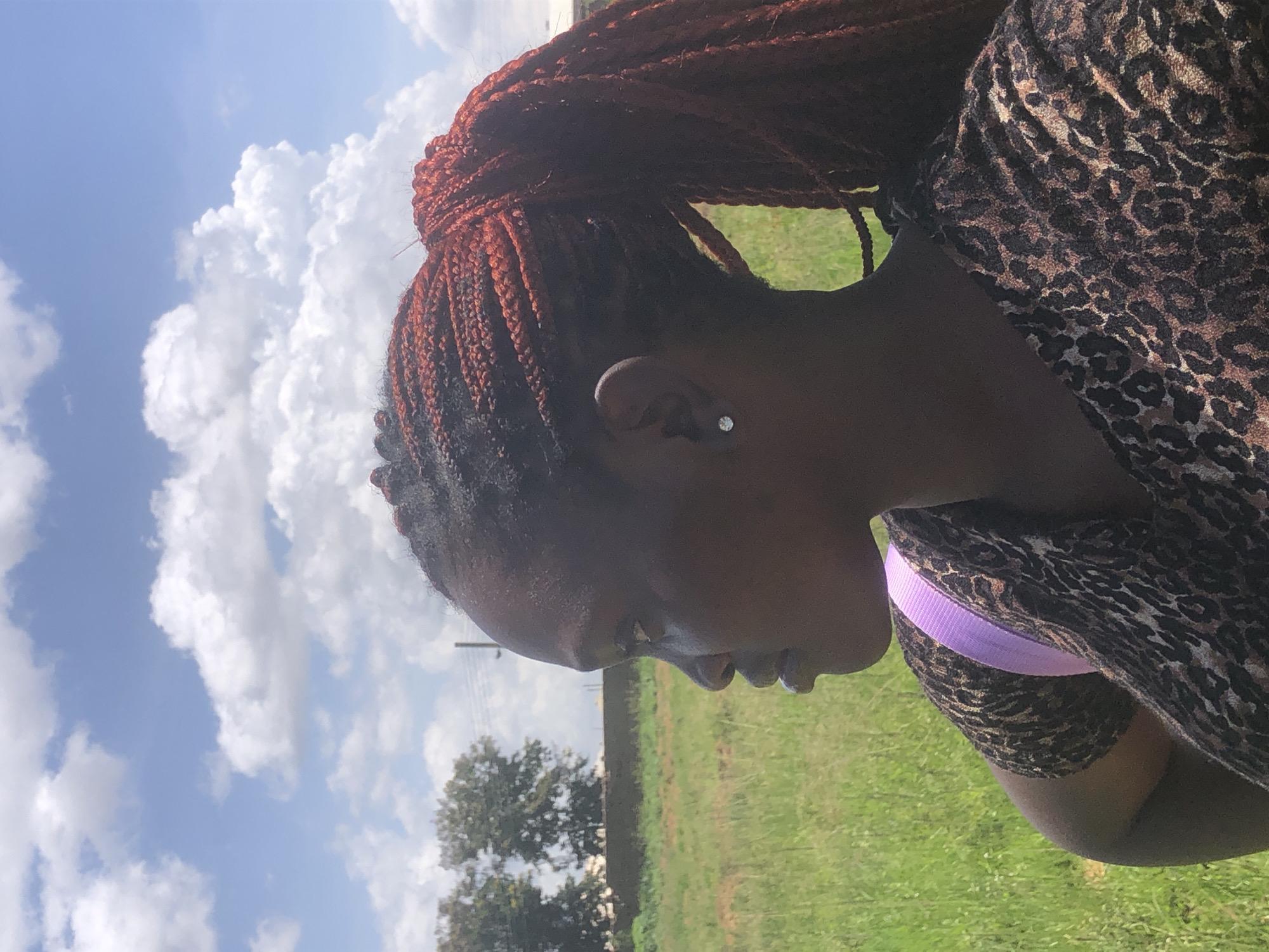 Shooting with a DSLR in a grassy field in Gwafan, Nigeria