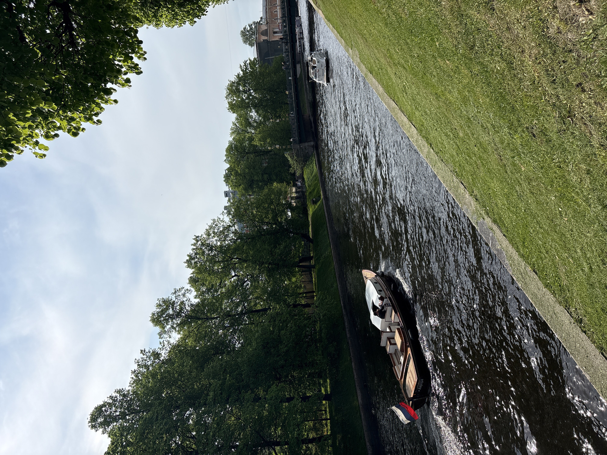 Tourist boats and pedestrians active in Saint Petersburg canals