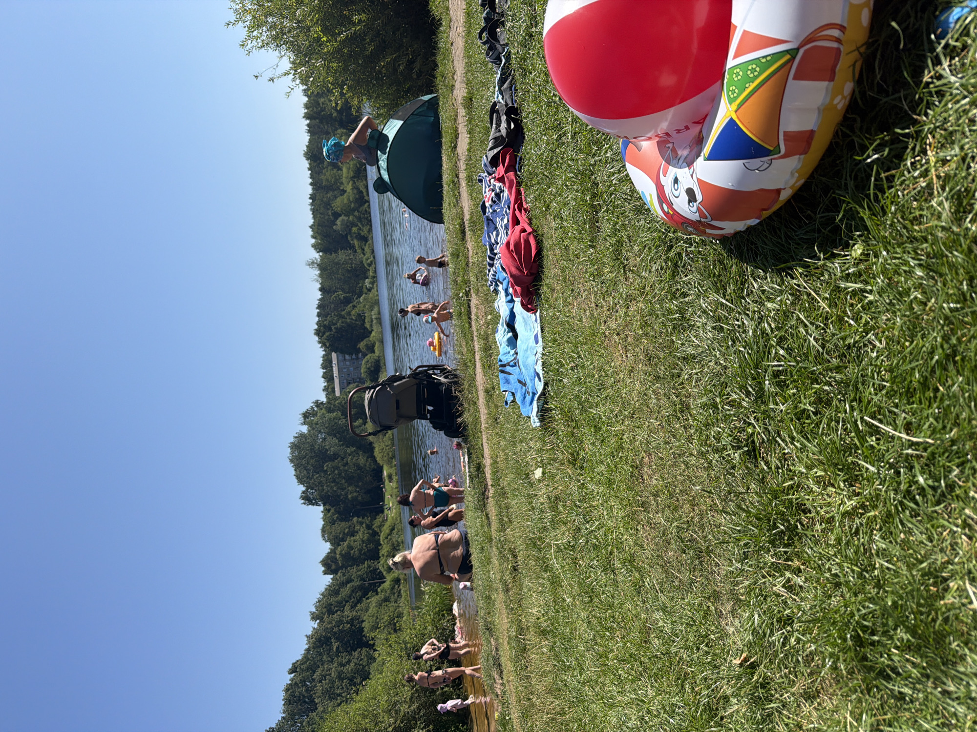 Sunny lakeside hangout in Riga with toys and swimmers