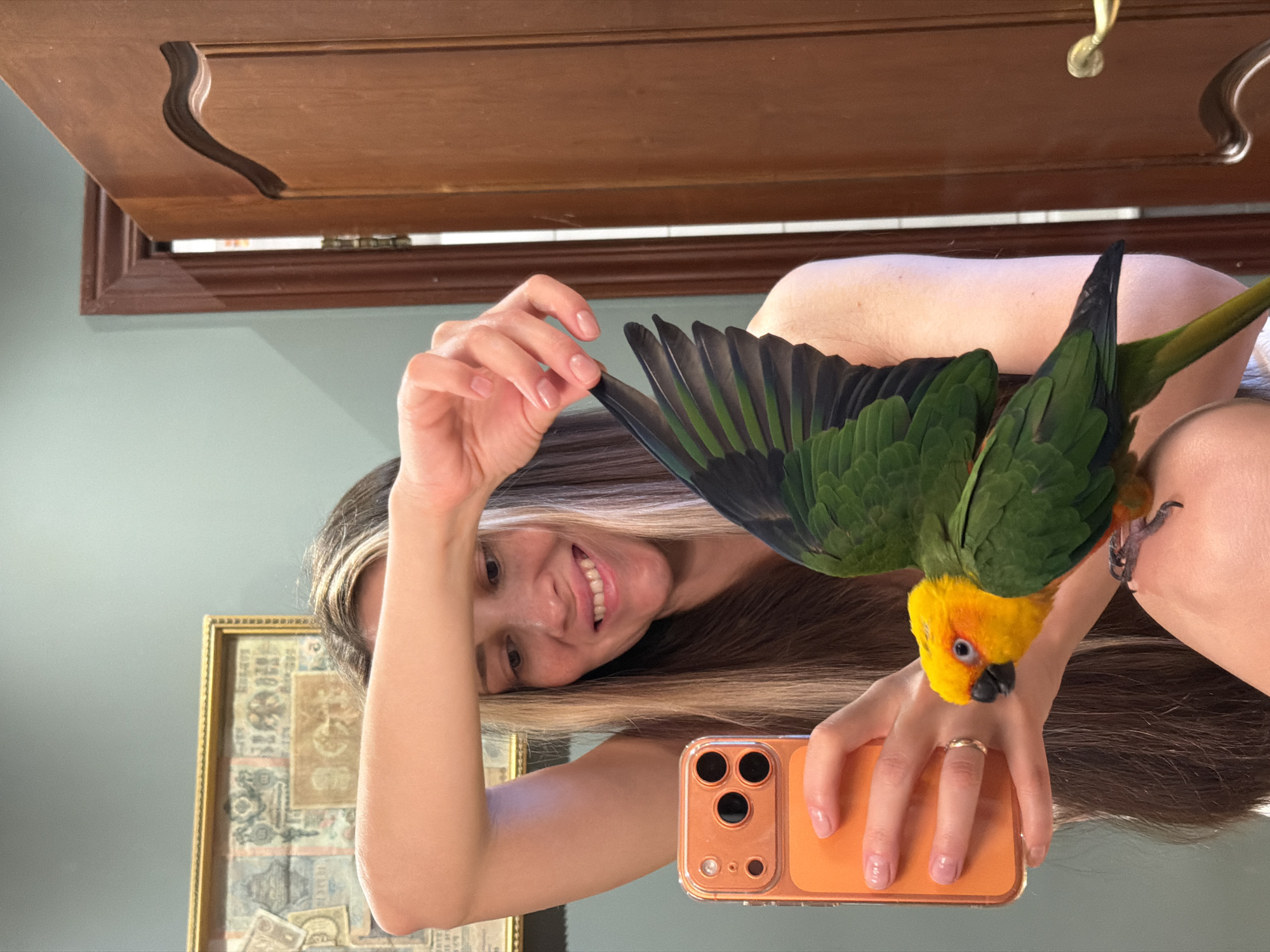 Woman photographs pet parrot session in Khimki suburb