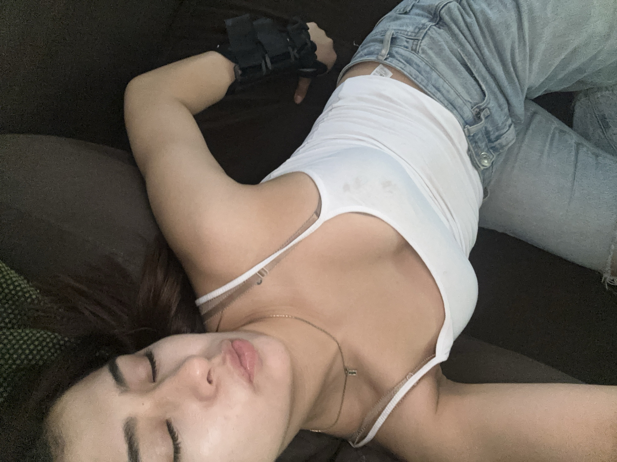 Person rests with small dog indoors in Puebla
