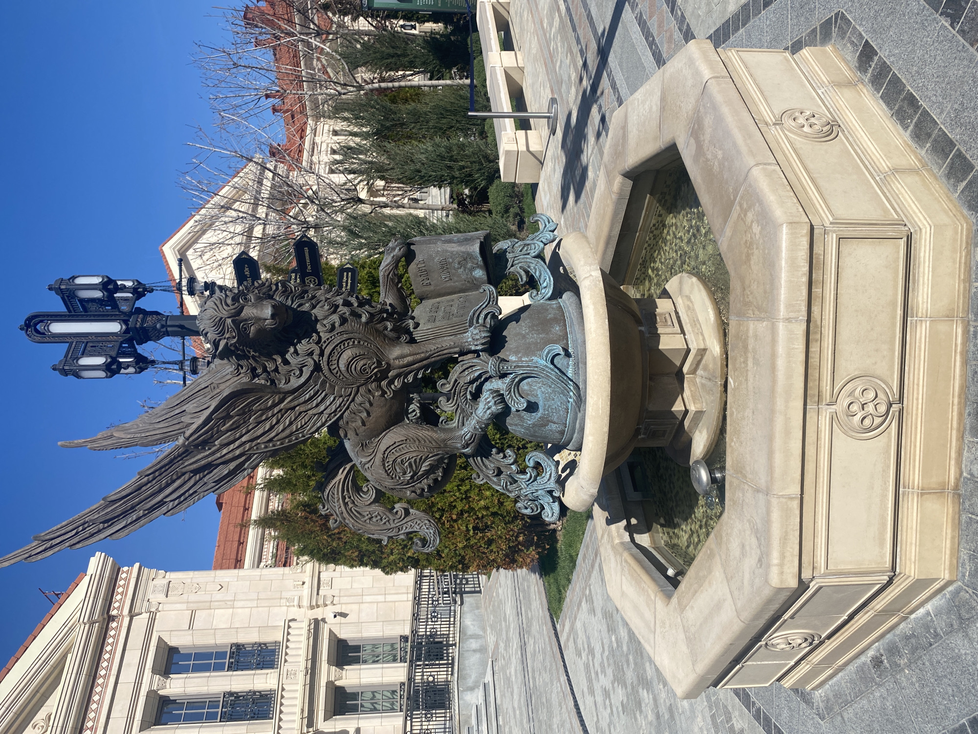 Family visits ornate fountain square in Sevastopol on sunny morning