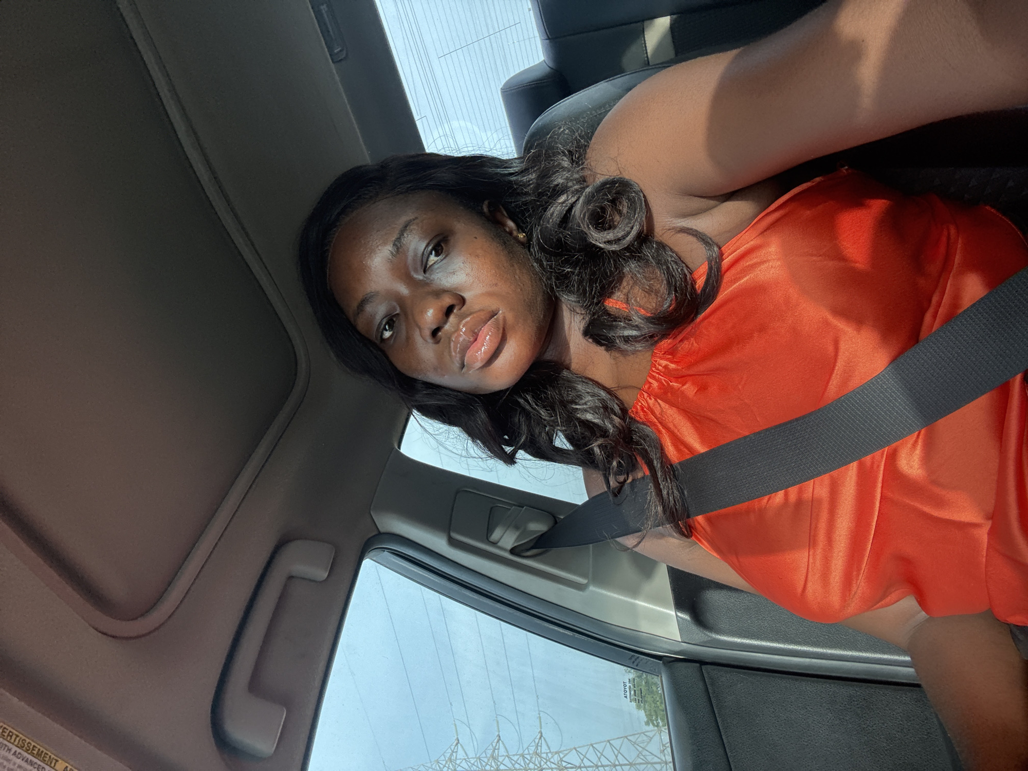 Woman in orange observed in vehicle, Kuchingoro Nigeria