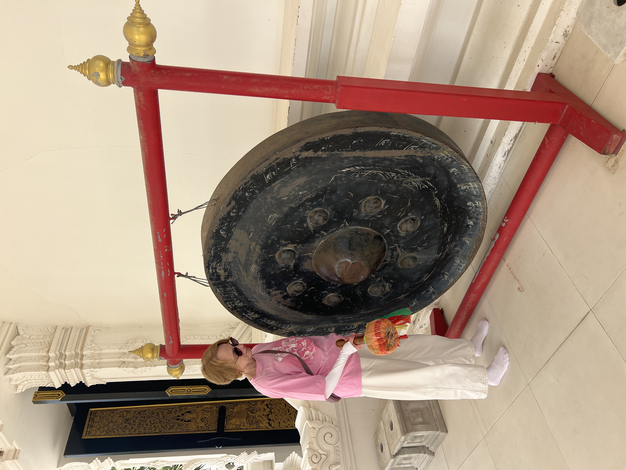Temple visitors experience Buddhist rituals and sacred art in Thailand