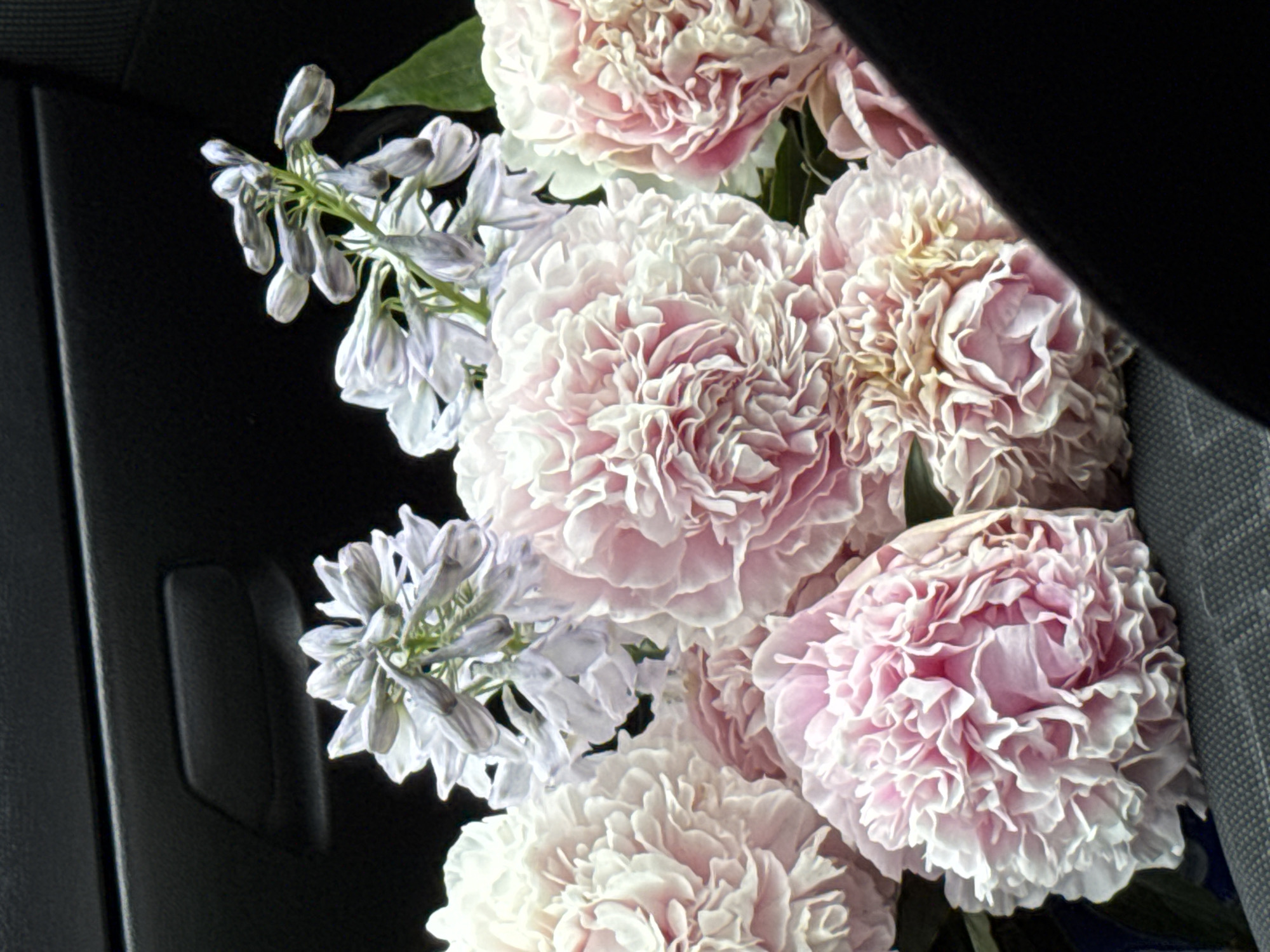 Fresh flower bouquet riding along in a car in Izhevsk