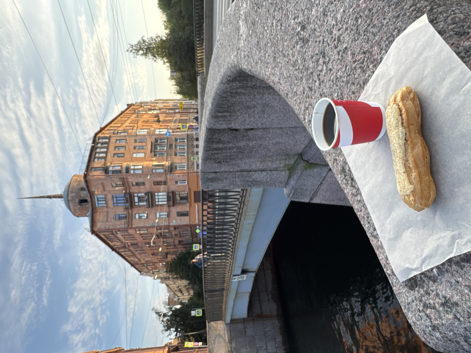Coffee, pastry, and a pigeon on a St. Petersburg canal