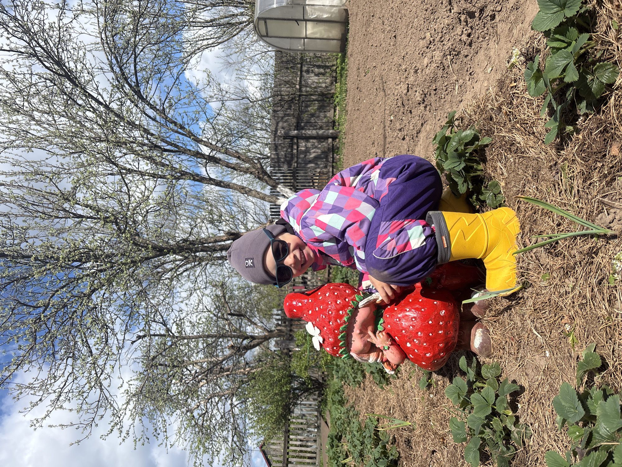 Child explores rural Russian farm property with bees, chickens