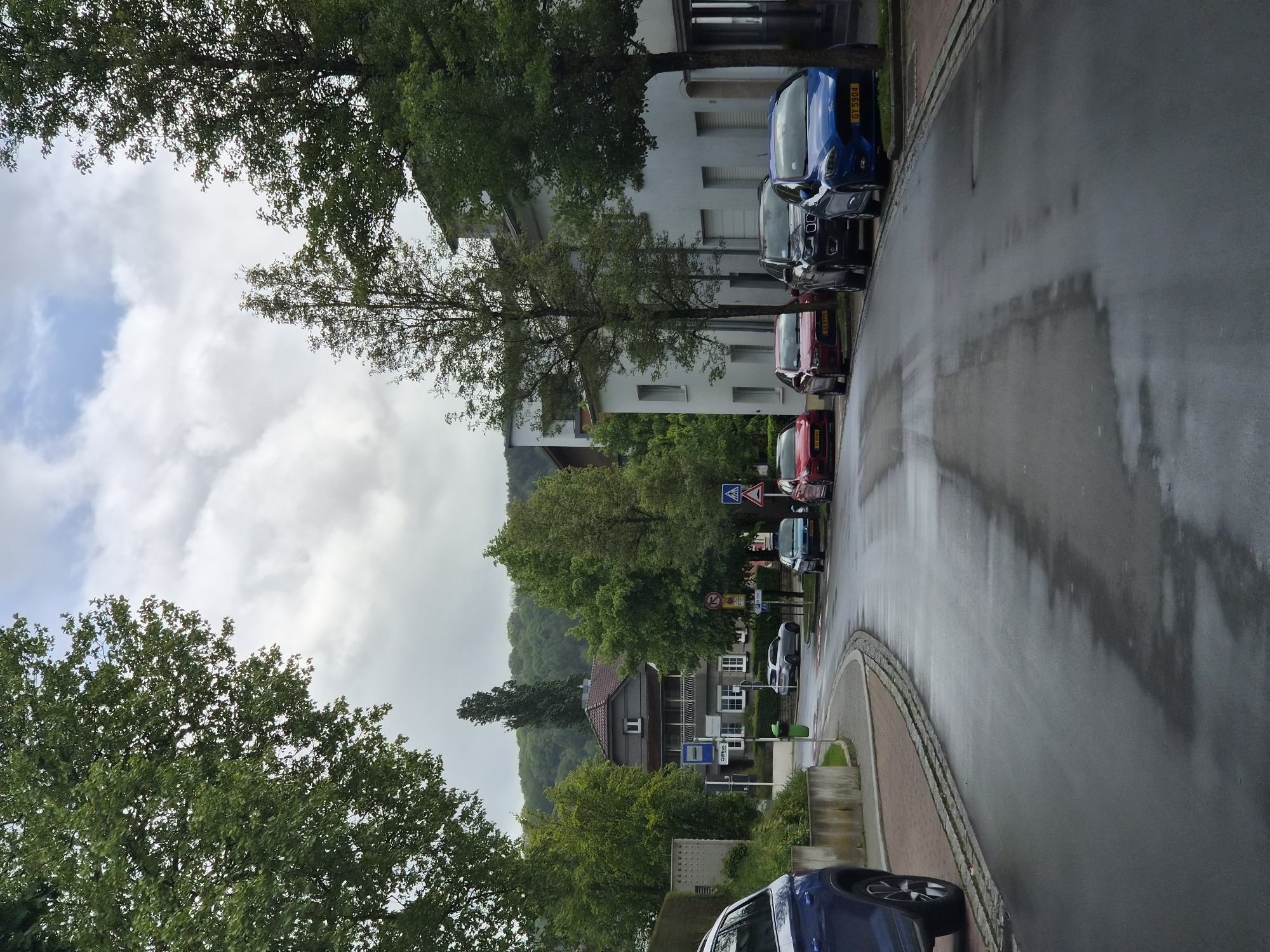 Wet streets reflect cloudy skies in Differdange after rain