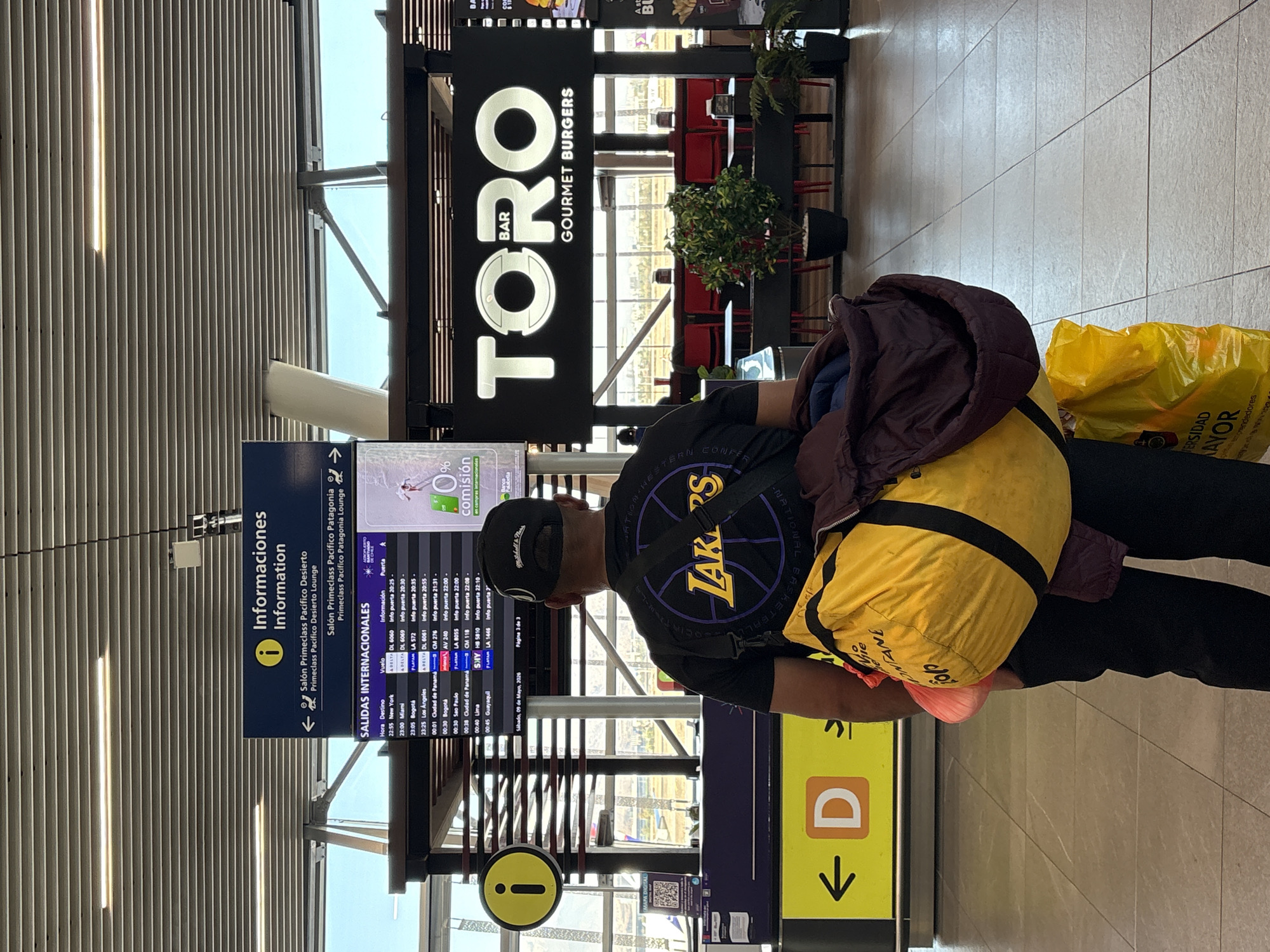 Evening travelers navigate Santiago airport terminals and retail areas