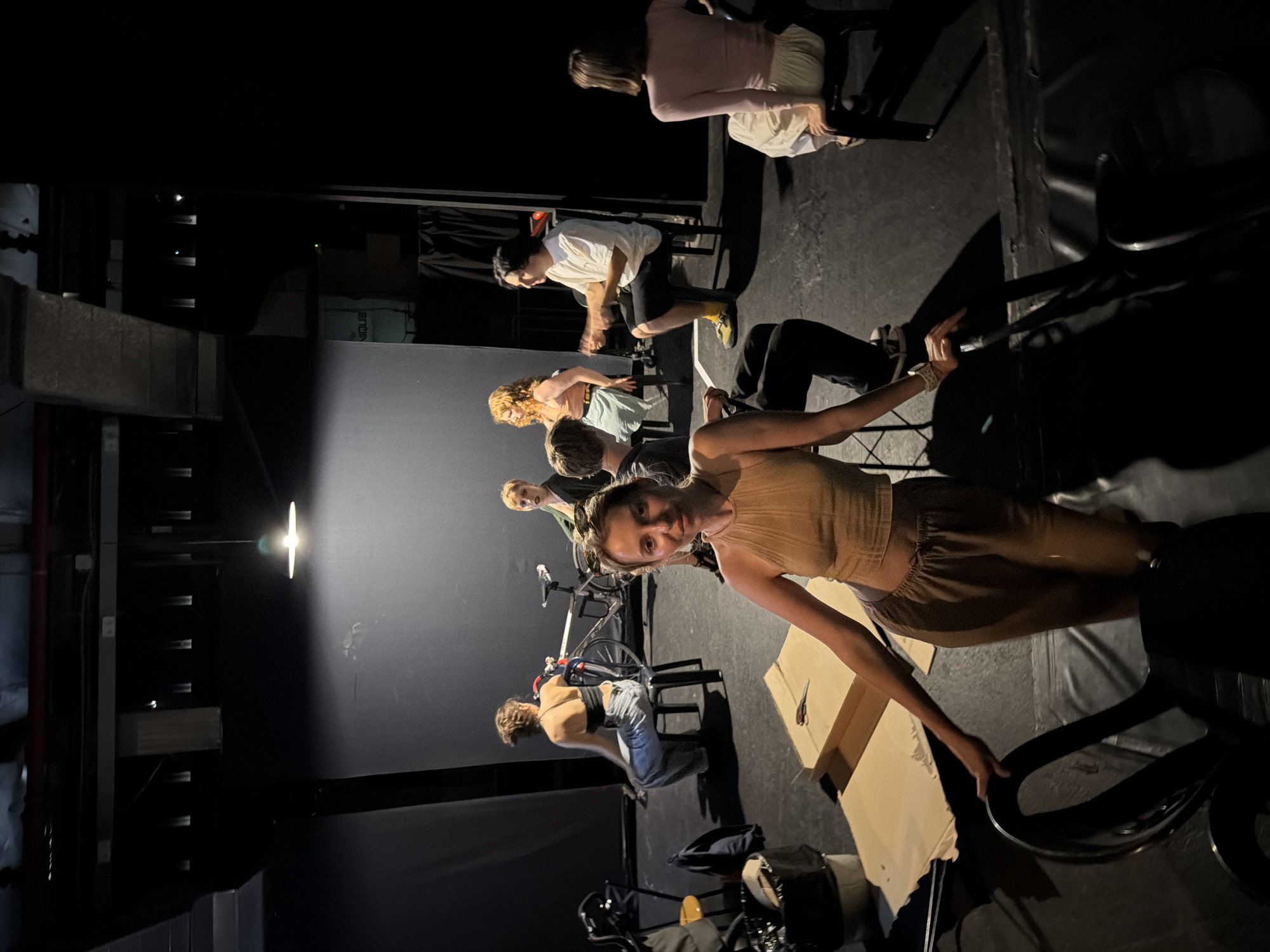 Theater group rehearses on a dim Tel Aviv stage with minimal set