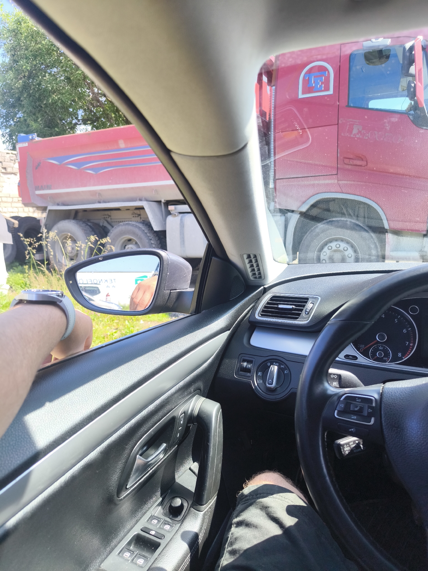 Volkswagen CC and crane truck parked on Tallinn gravel lot