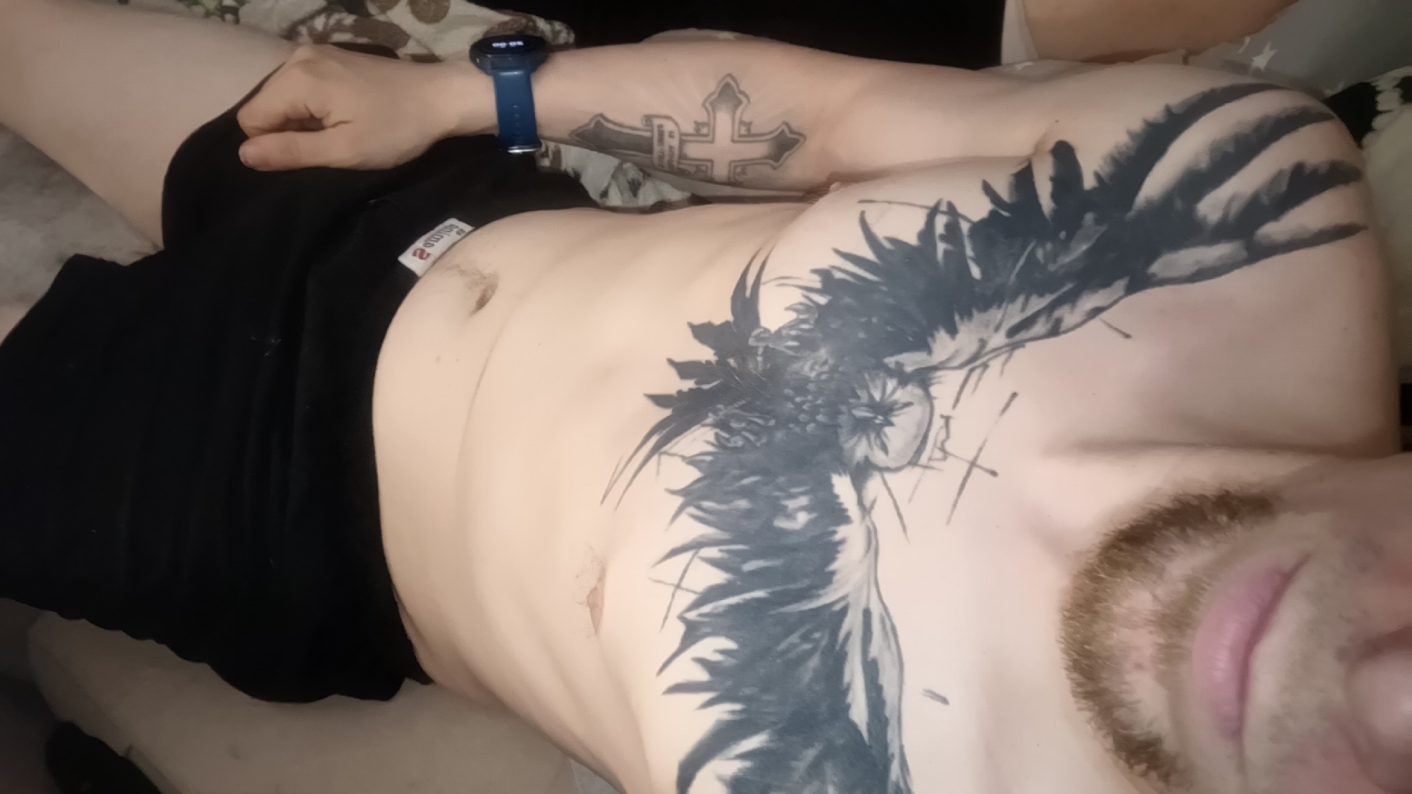 Casual indoor evening shots centered on a detailed owl chest tattoo