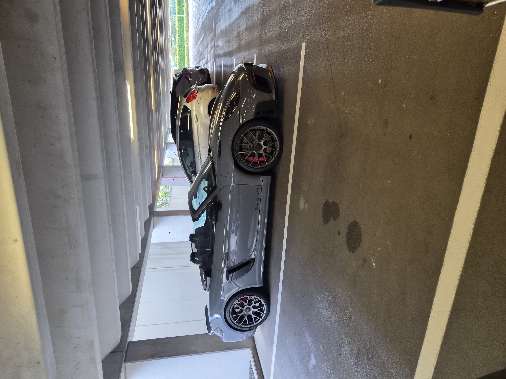Gray Porsche spotted at Luxembourg parking garage near power lines