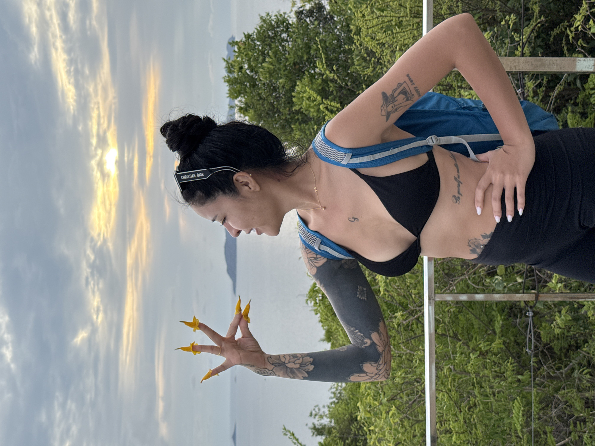 Woman enjoys sunset vista in Pattaya with backpack