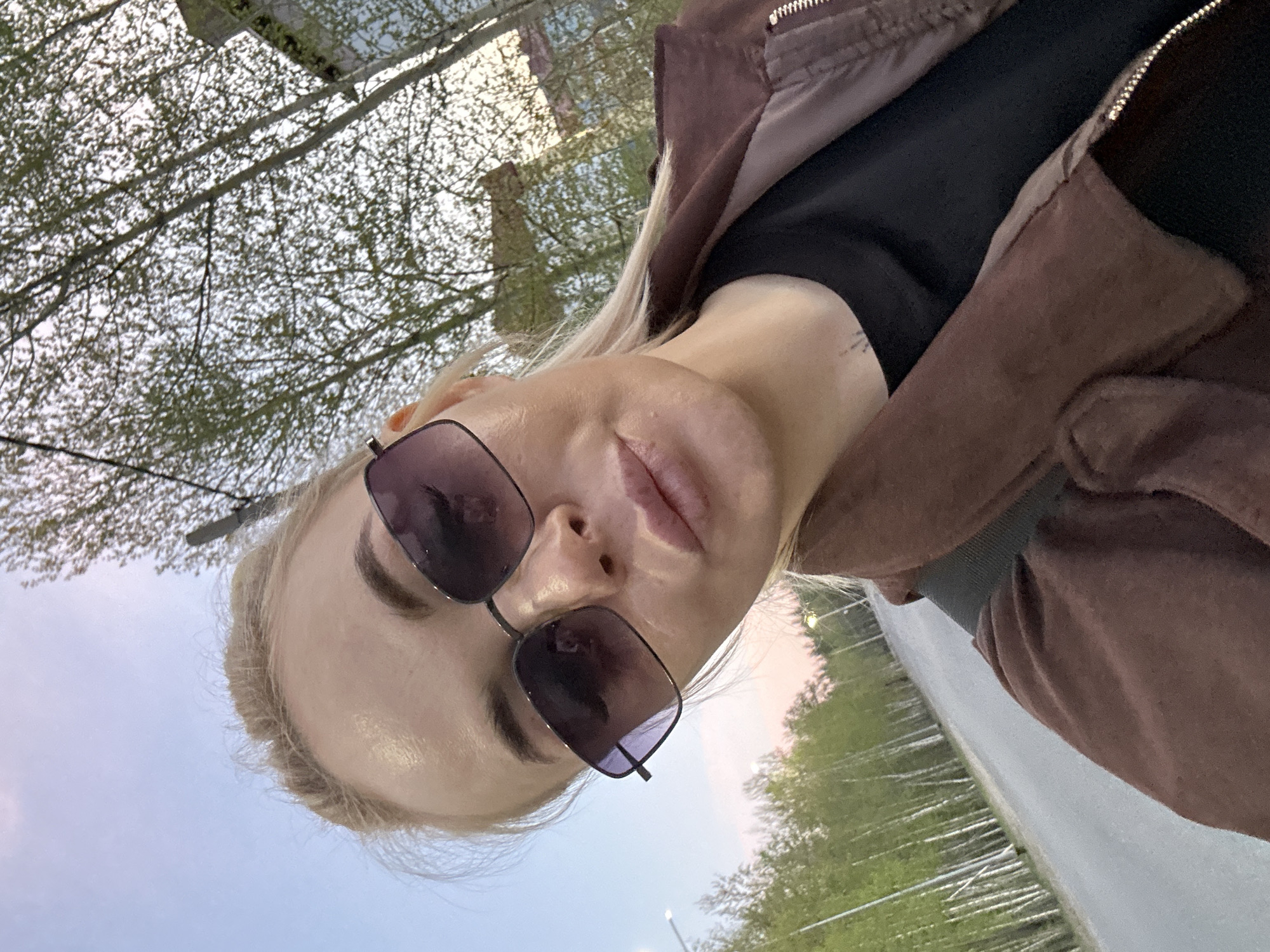 Woman takes selfies during outdoor walk in Высокий, Russia