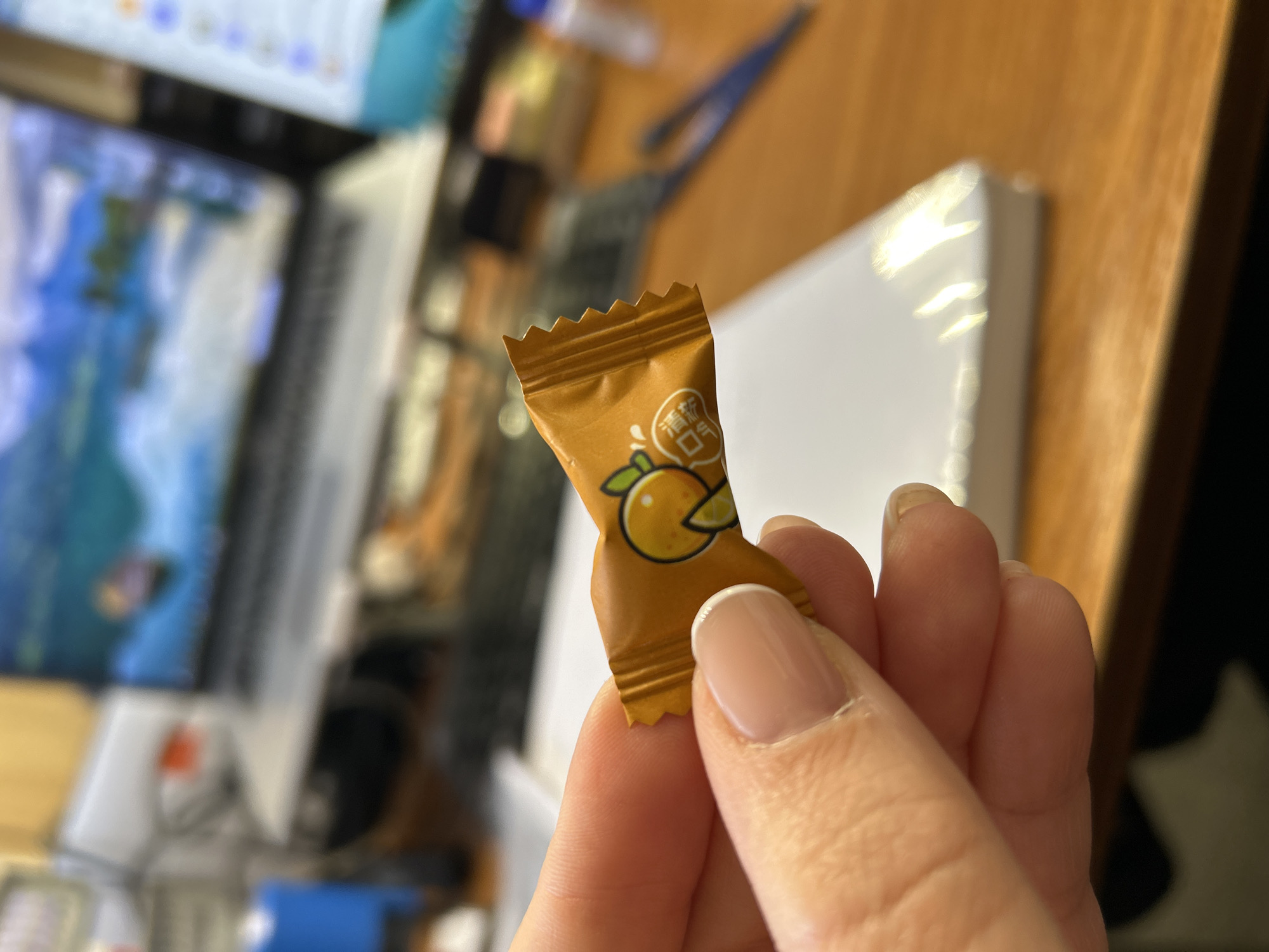 Person holds Chinese orange candy in Russian town