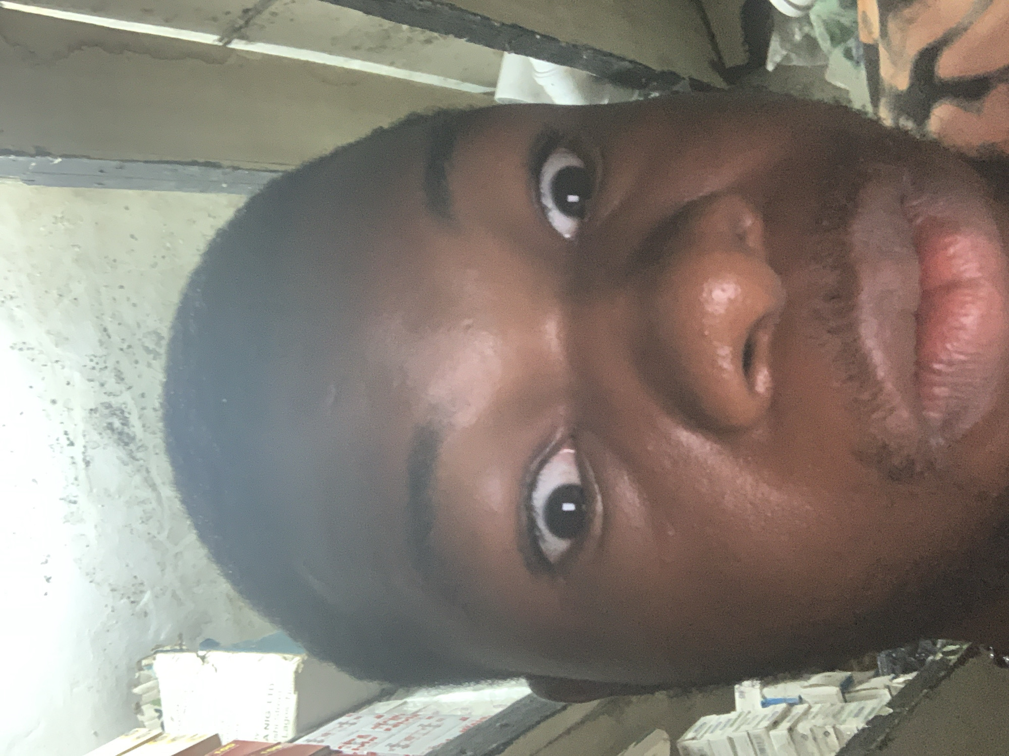 Portrait session documented at Nigerian pharmacy counter