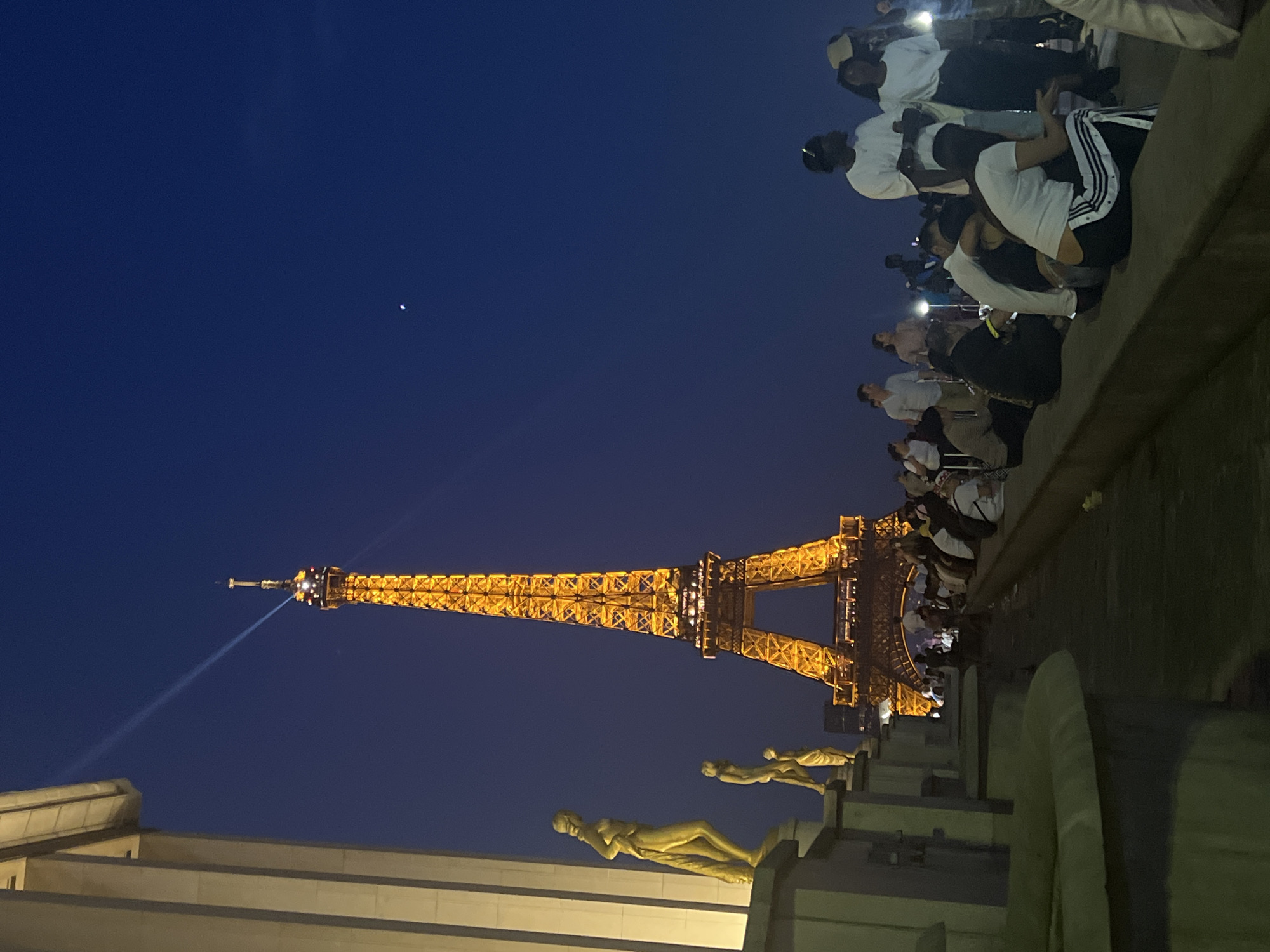 Eiffel Tower glowing at dusk, Paris evening in full effect