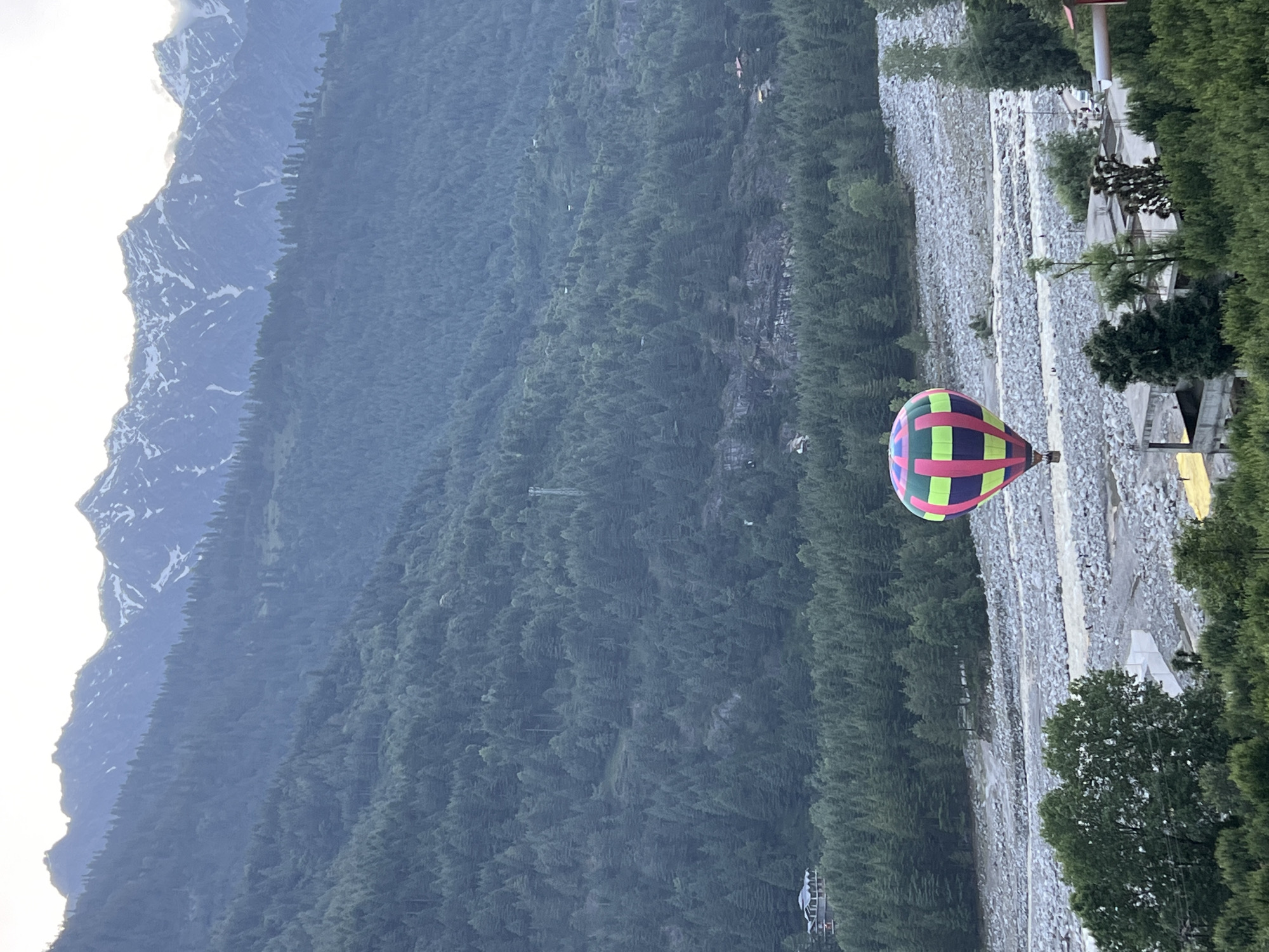 Hot air balloon ascends over Himalayan valley in Vashisht