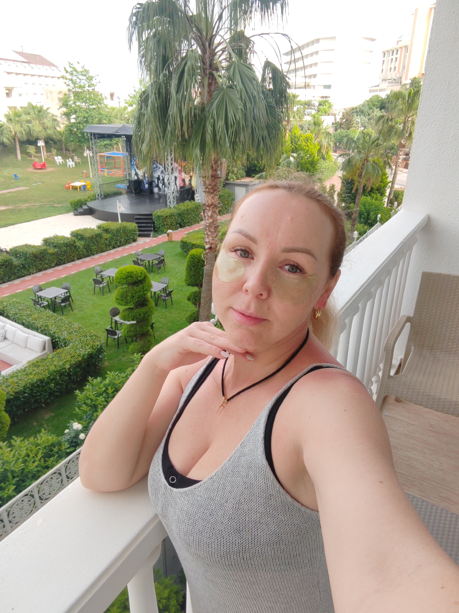Woman captures morning selfie overlooking hotel stage in Alanya