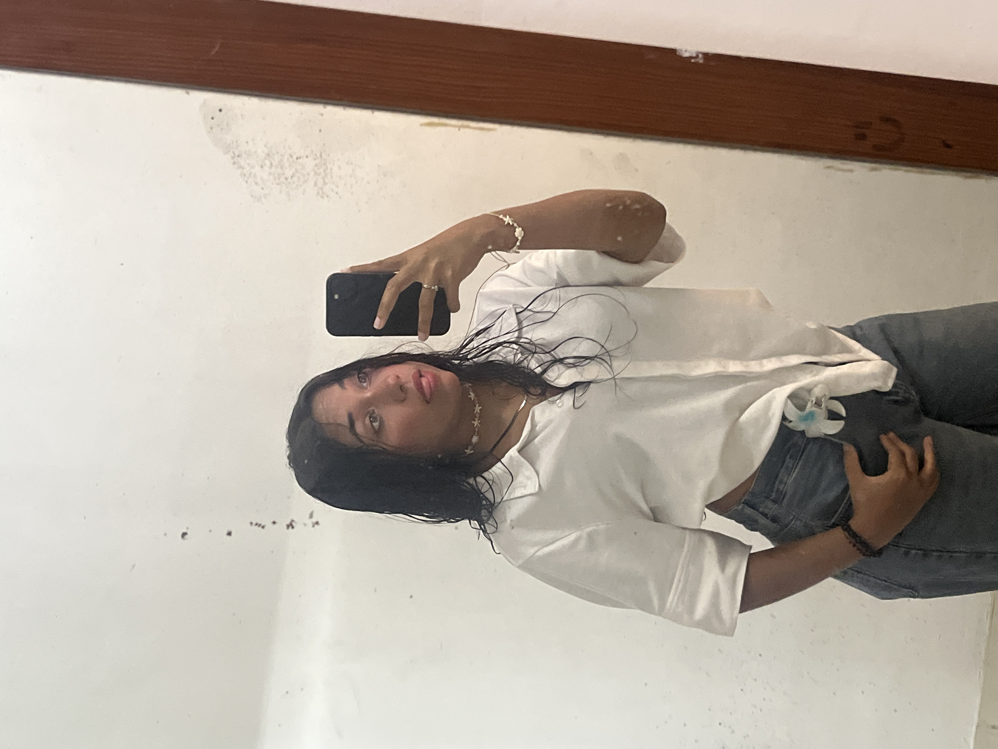 Woman takes mirror selfies in Pampatar, Venezuela bathroom