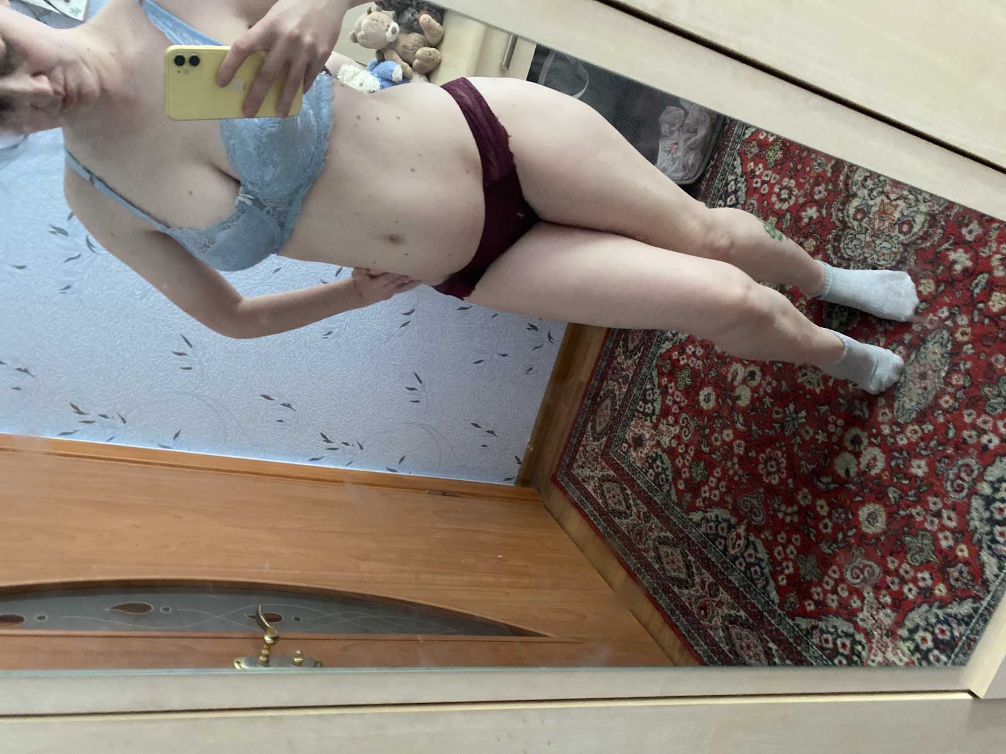 Mirror selfies across outfit changes in a blue-walled room