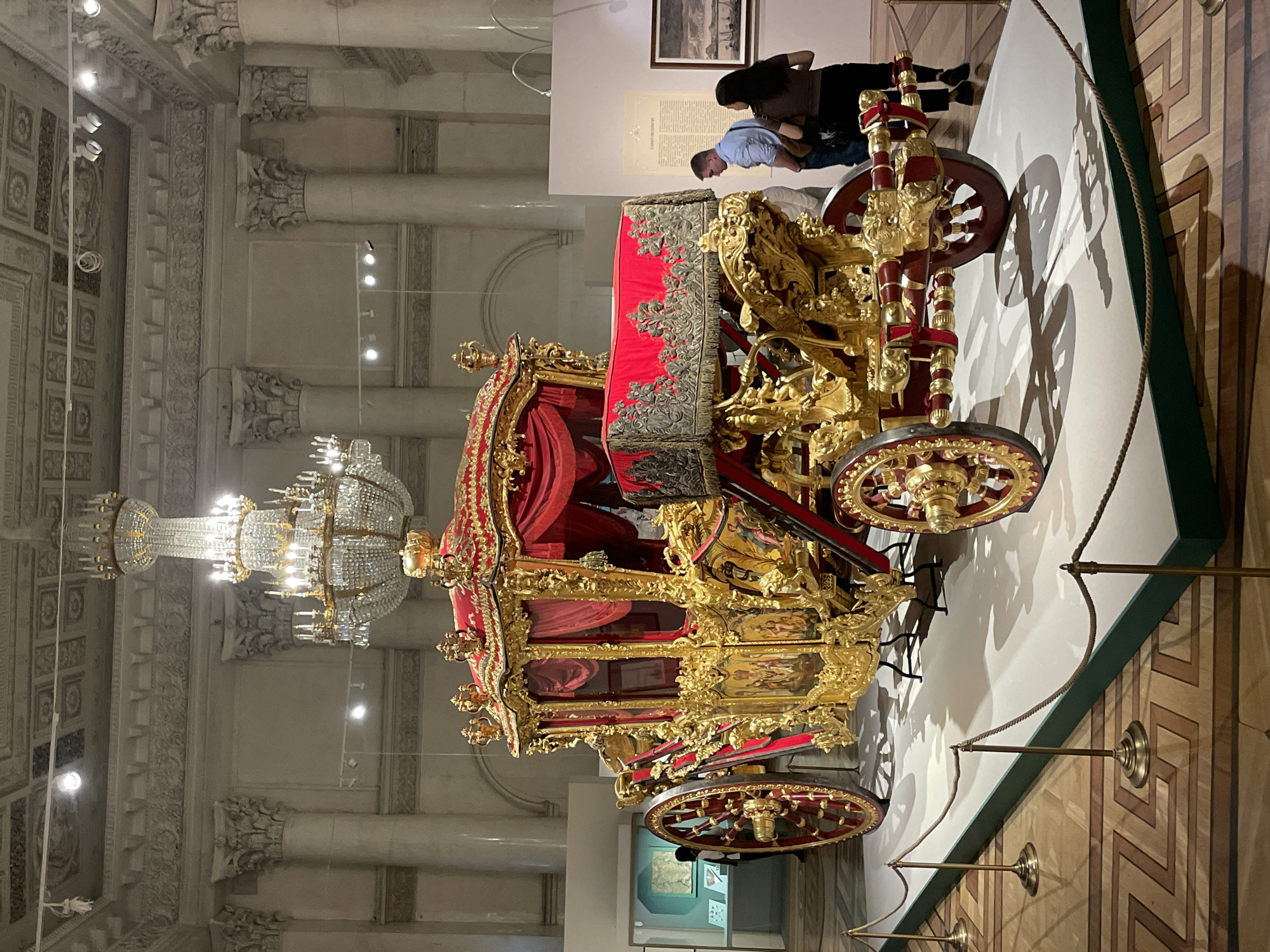 Historic ornate carriage displayed in unknown museum