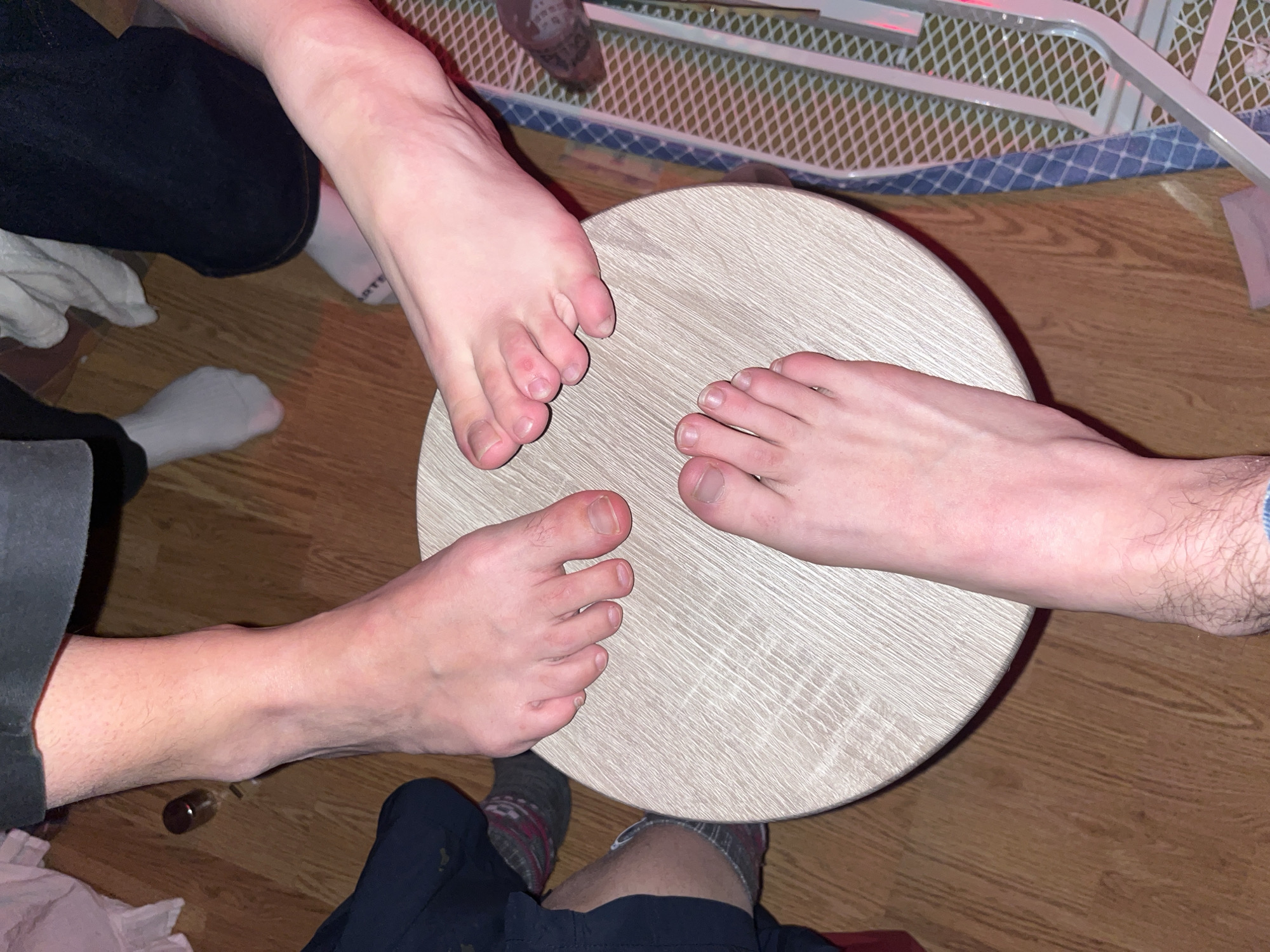 Three people gather barefoot around table in Strasbourg