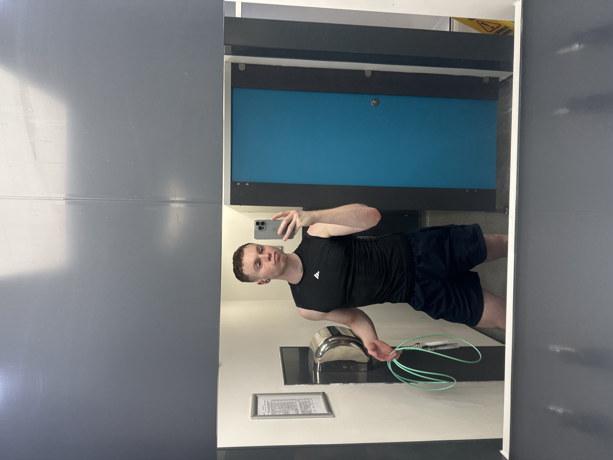 Man exercises with jump rope while using phone in London