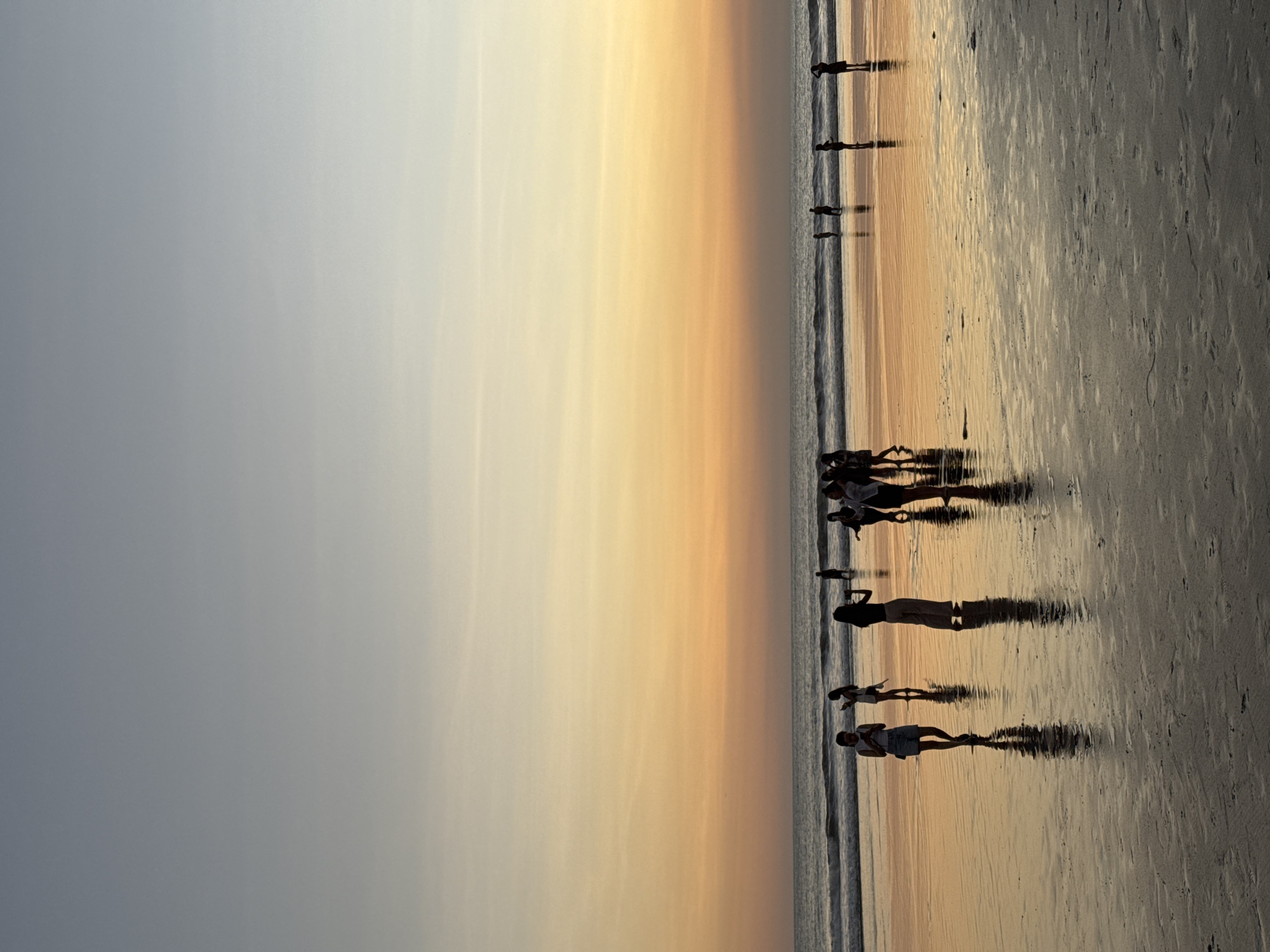 Kuta Beach fills up at golden hour on a June evening