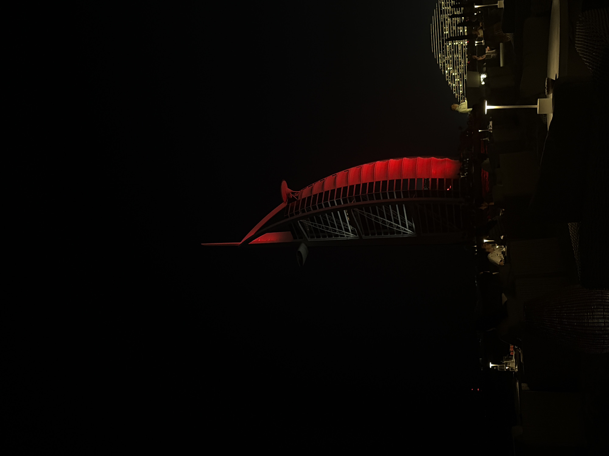 Dubai Water Canal Bridge illuminated with red lights at night