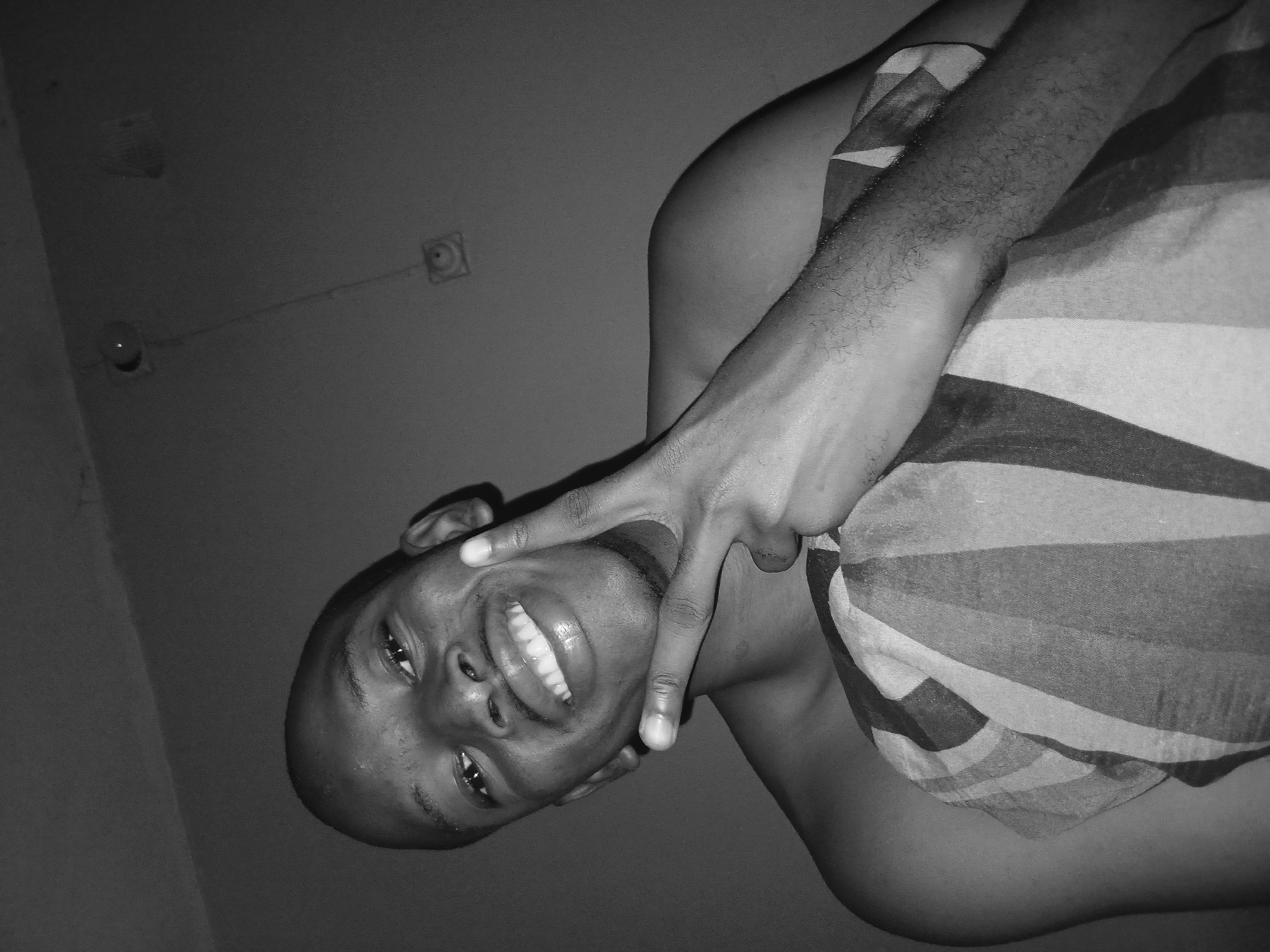 Goofing around in bed, sunglasses on, Lagos bedroom