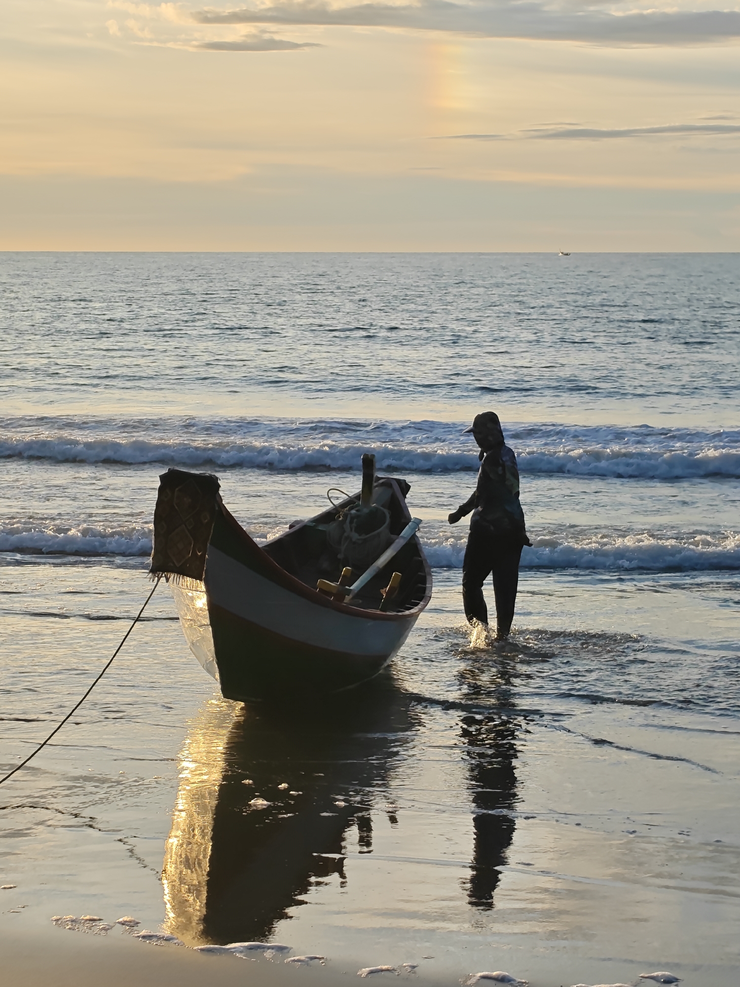 Fishing boats return to shore at sunset in Uleekareung, Aceh