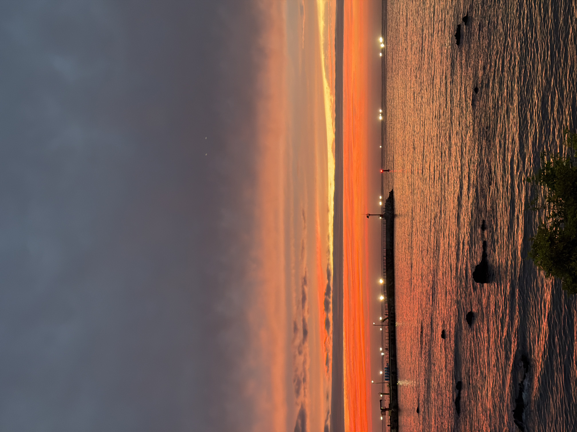 Jeju City coastline at golden hour, dusk settling in