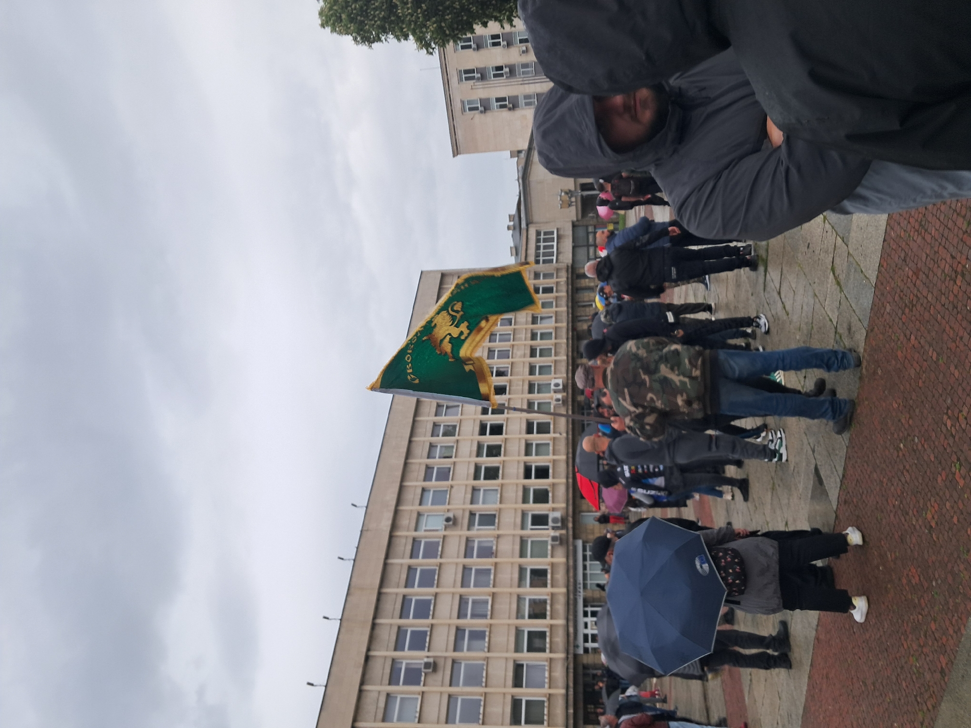 Crowd gathers in rainy Gabrovo square near school