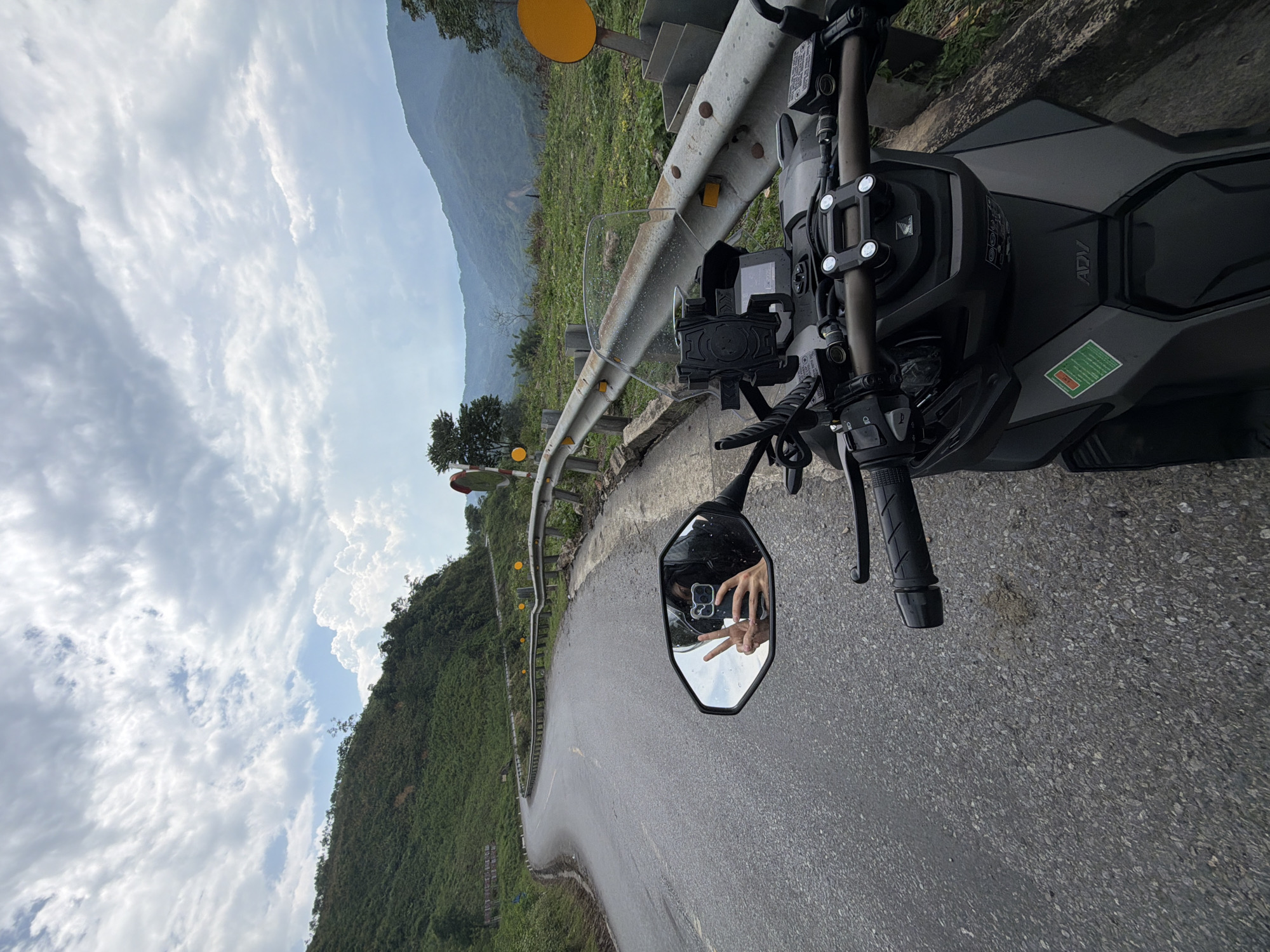 Motorcyclist rides winding mountain road near Huế, Vietnam
