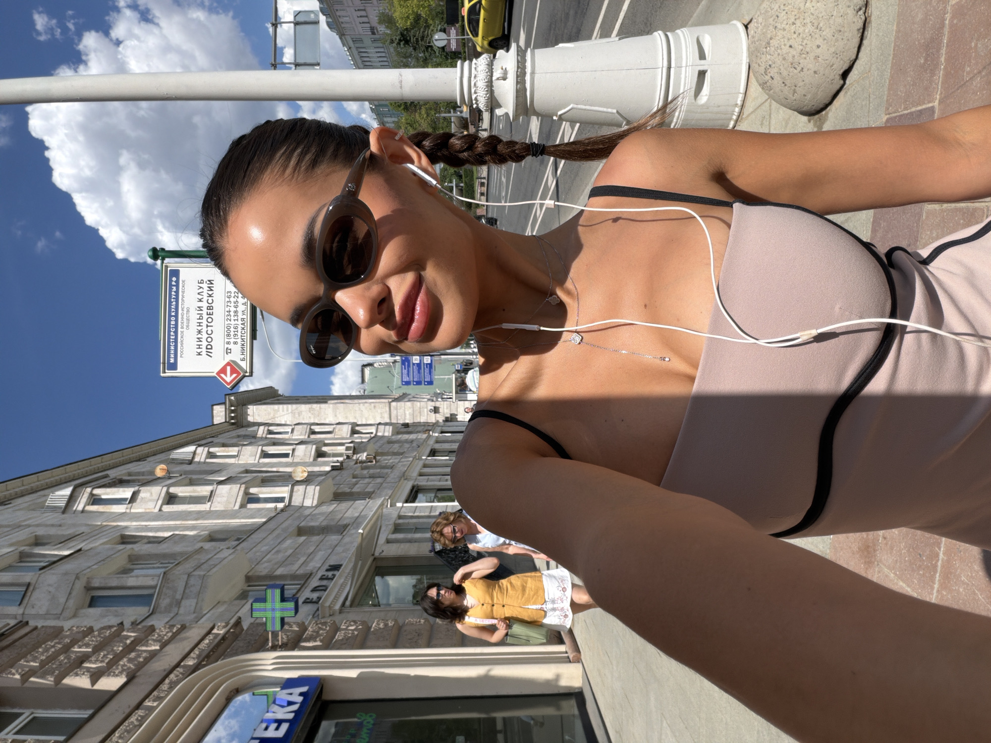 Woman takes selfies on sunny Moscow street