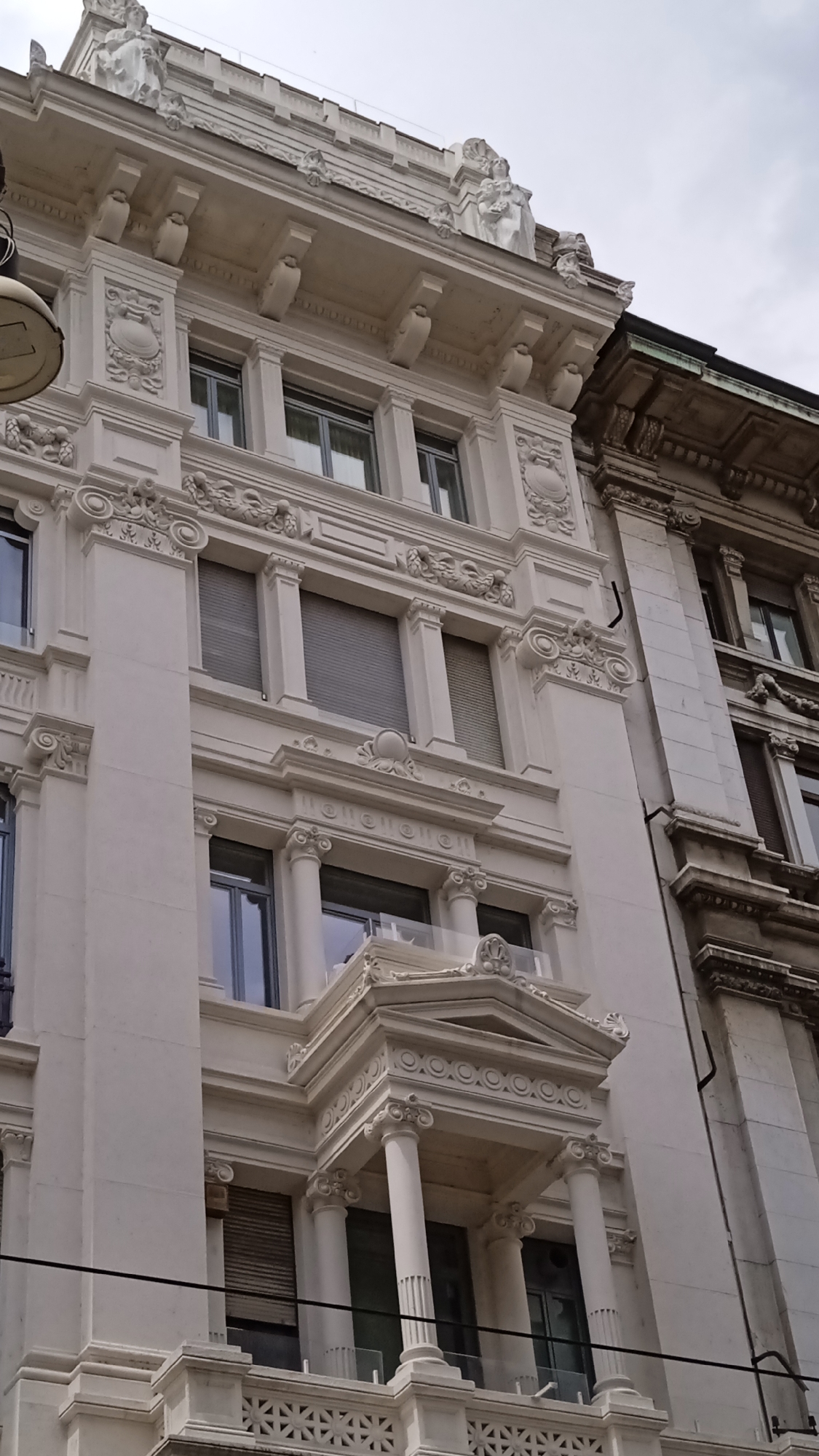 Ornate facades and San Sebastiano church in central Milan