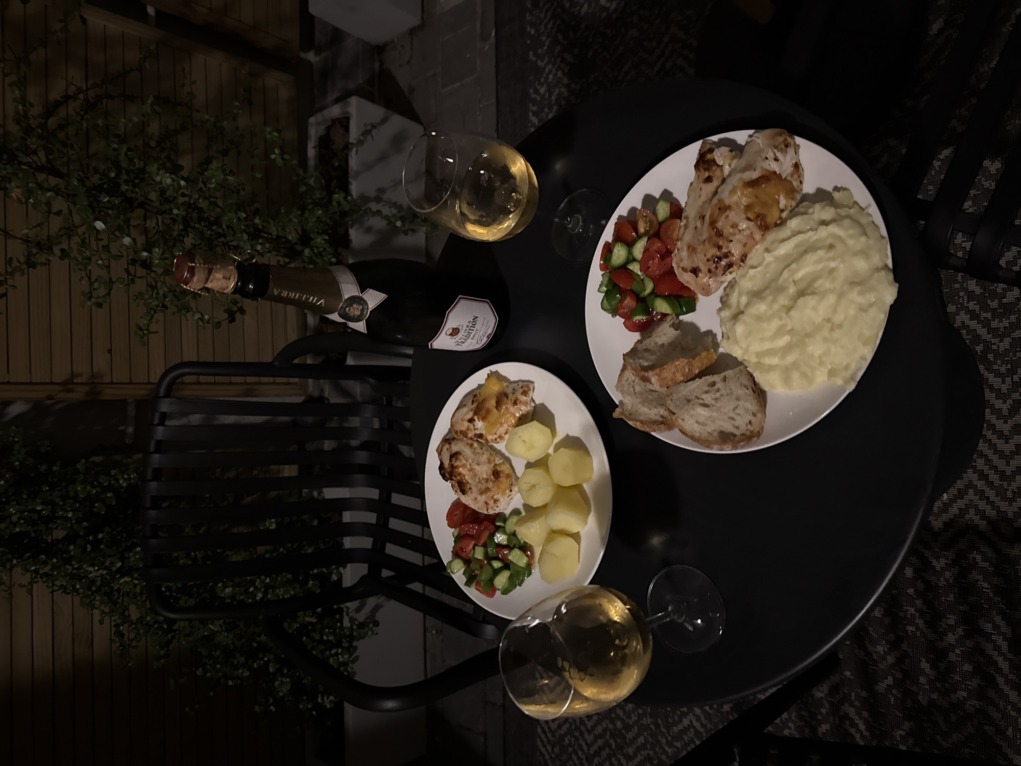 Cape Town dinner documented with chicken, wine on outdoor table